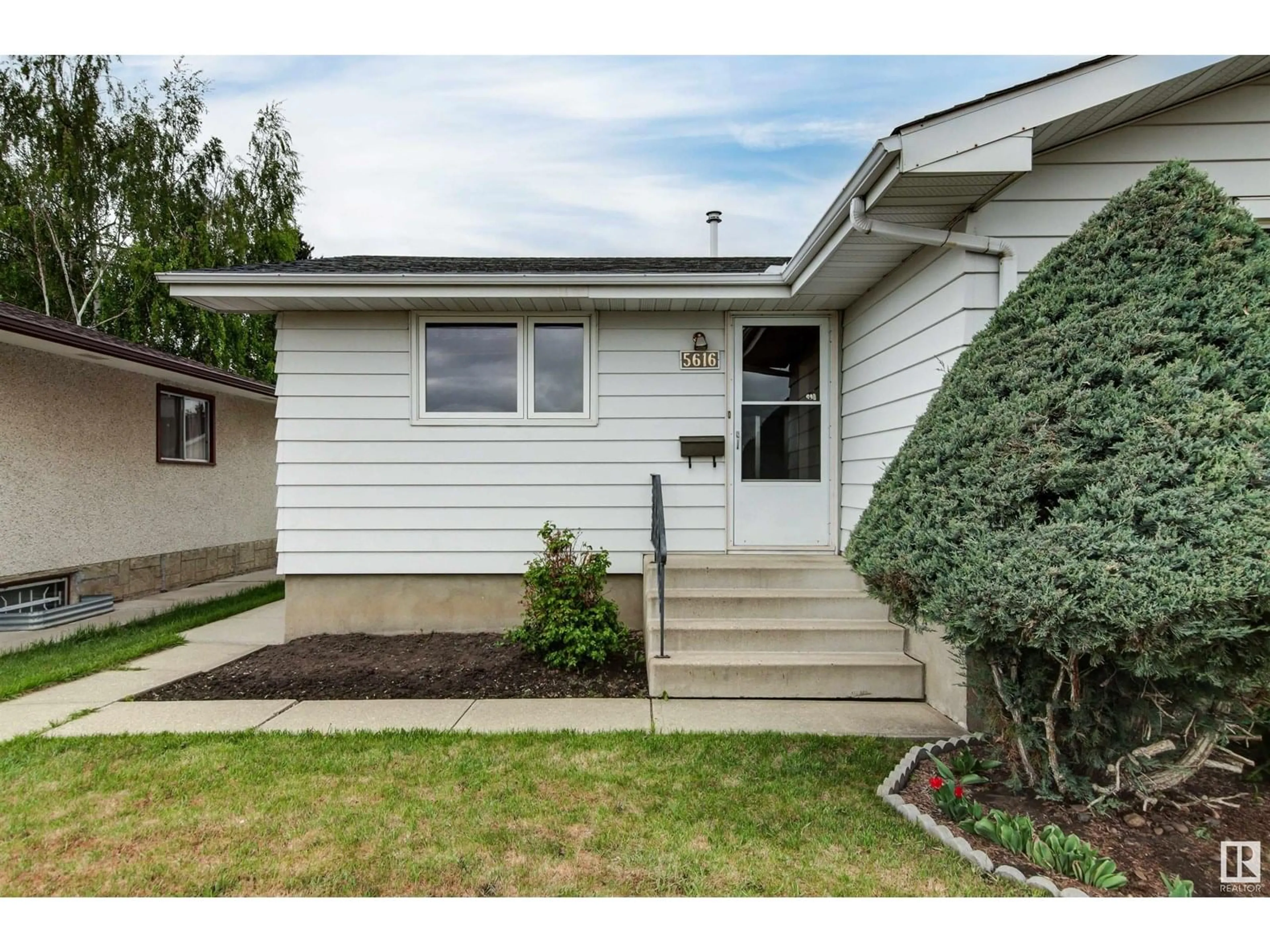 Home with vinyl exterior material, street for NW - 5616 140A AV, Edmonton Alberta T5A1H3