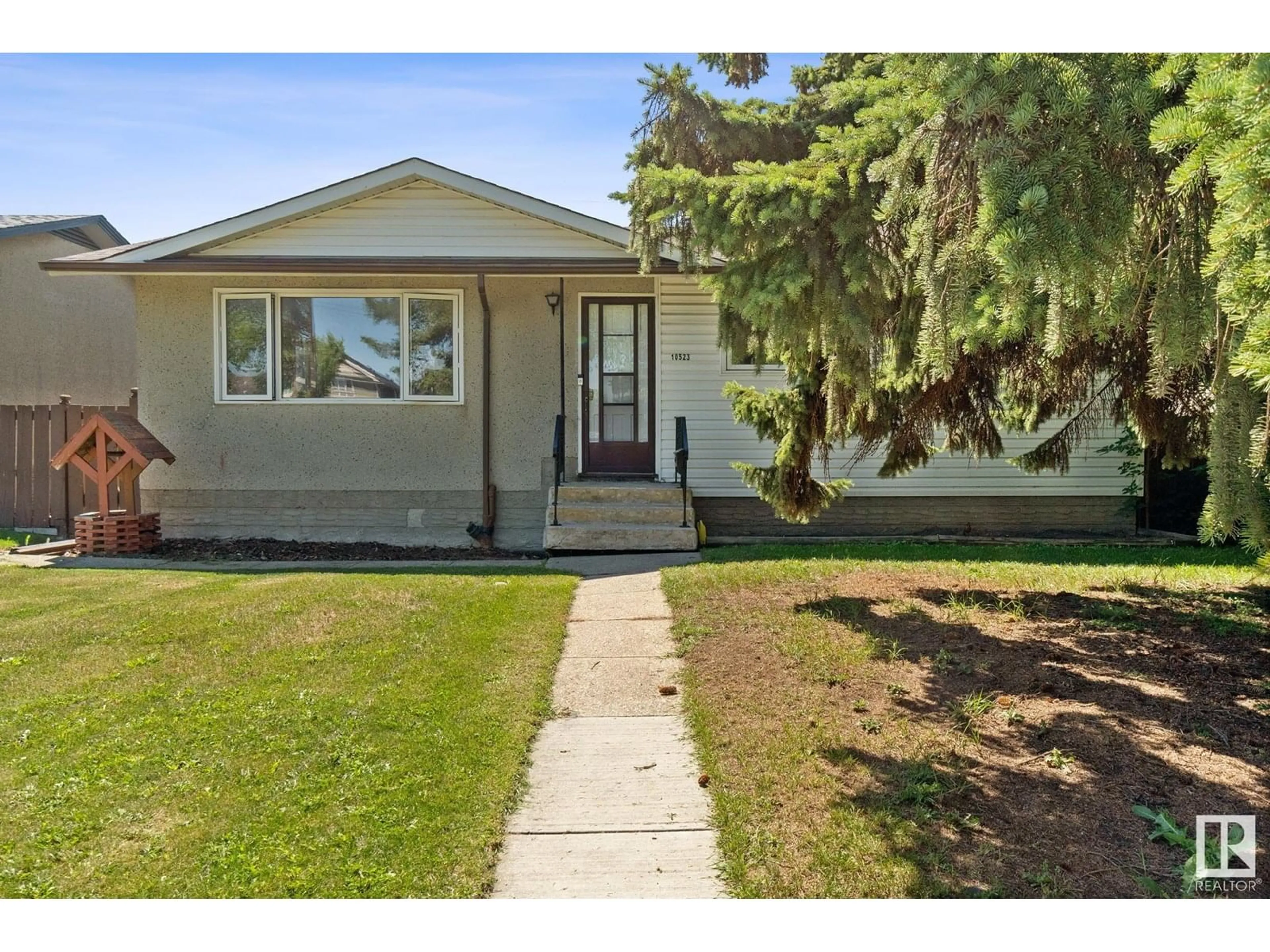 Home with vinyl exterior material, street for 10523 137 AV, Edmonton Alberta T5E1Z1