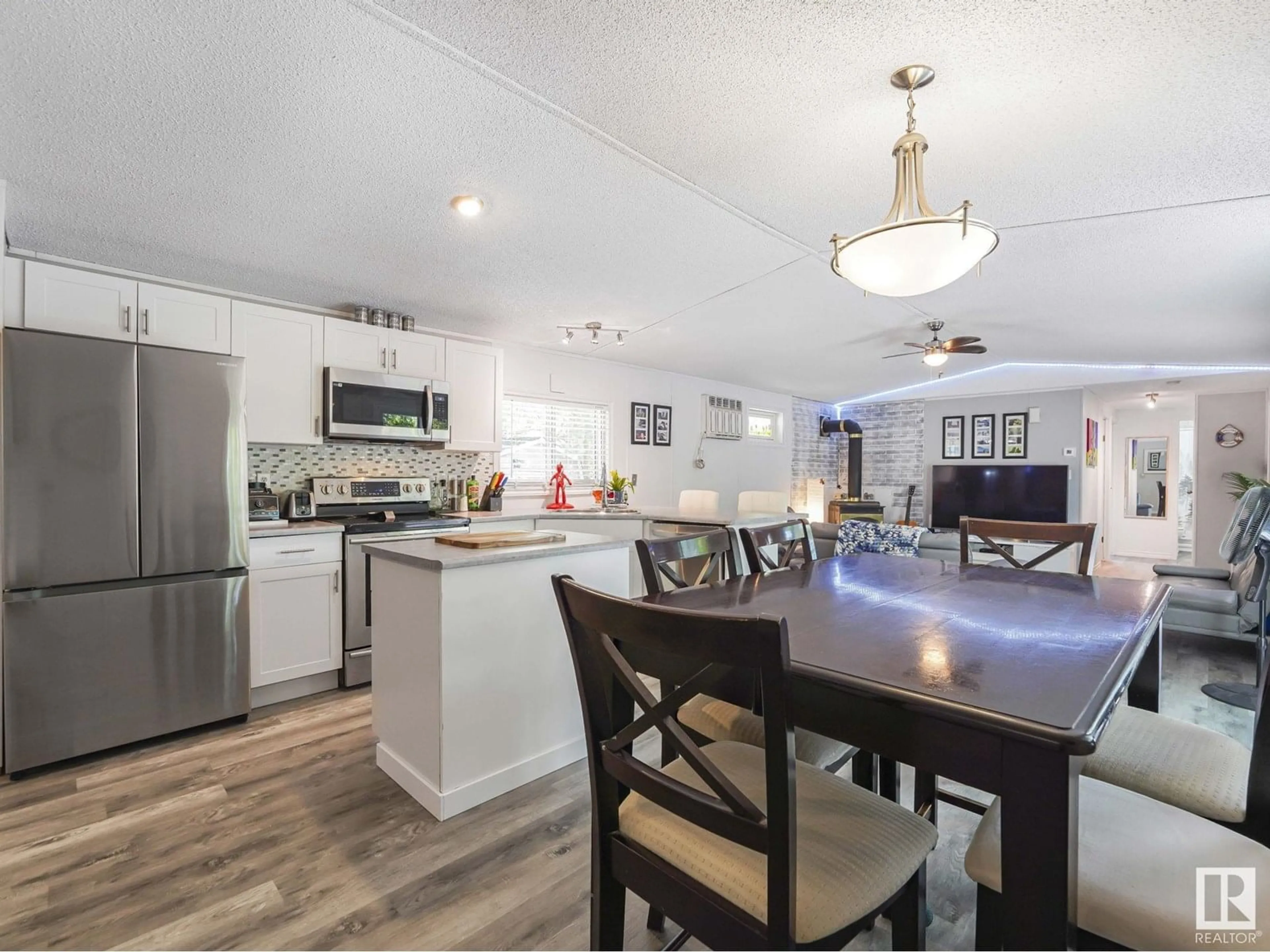 Open concept kitchen, wood/laminate floor for 304 57323 RGRD 30, Rural Barrhead County Alberta T7N1N4