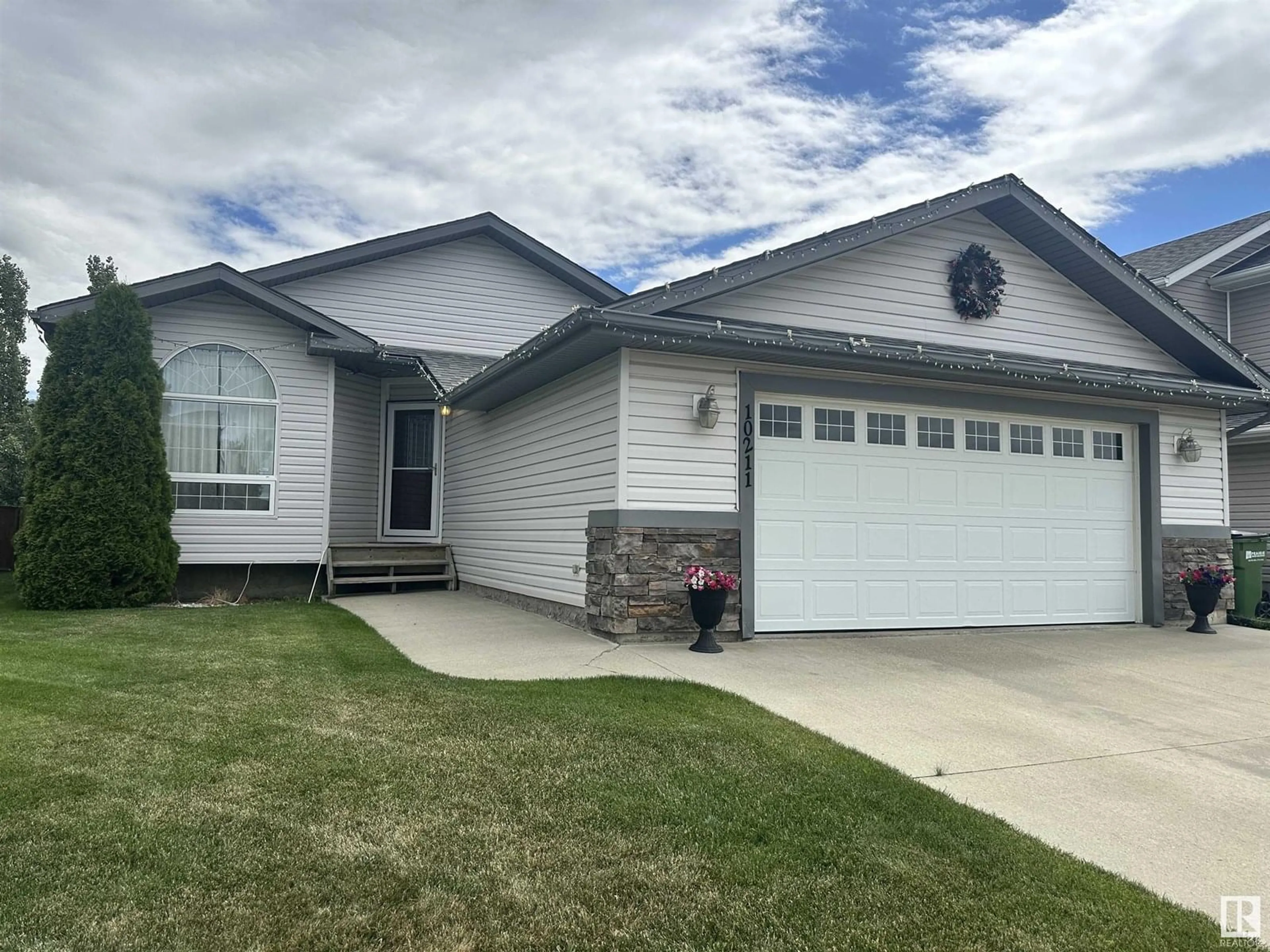 Home with vinyl exterior material, street for 10211 110 AV, Westlock Alberta T7P2S1