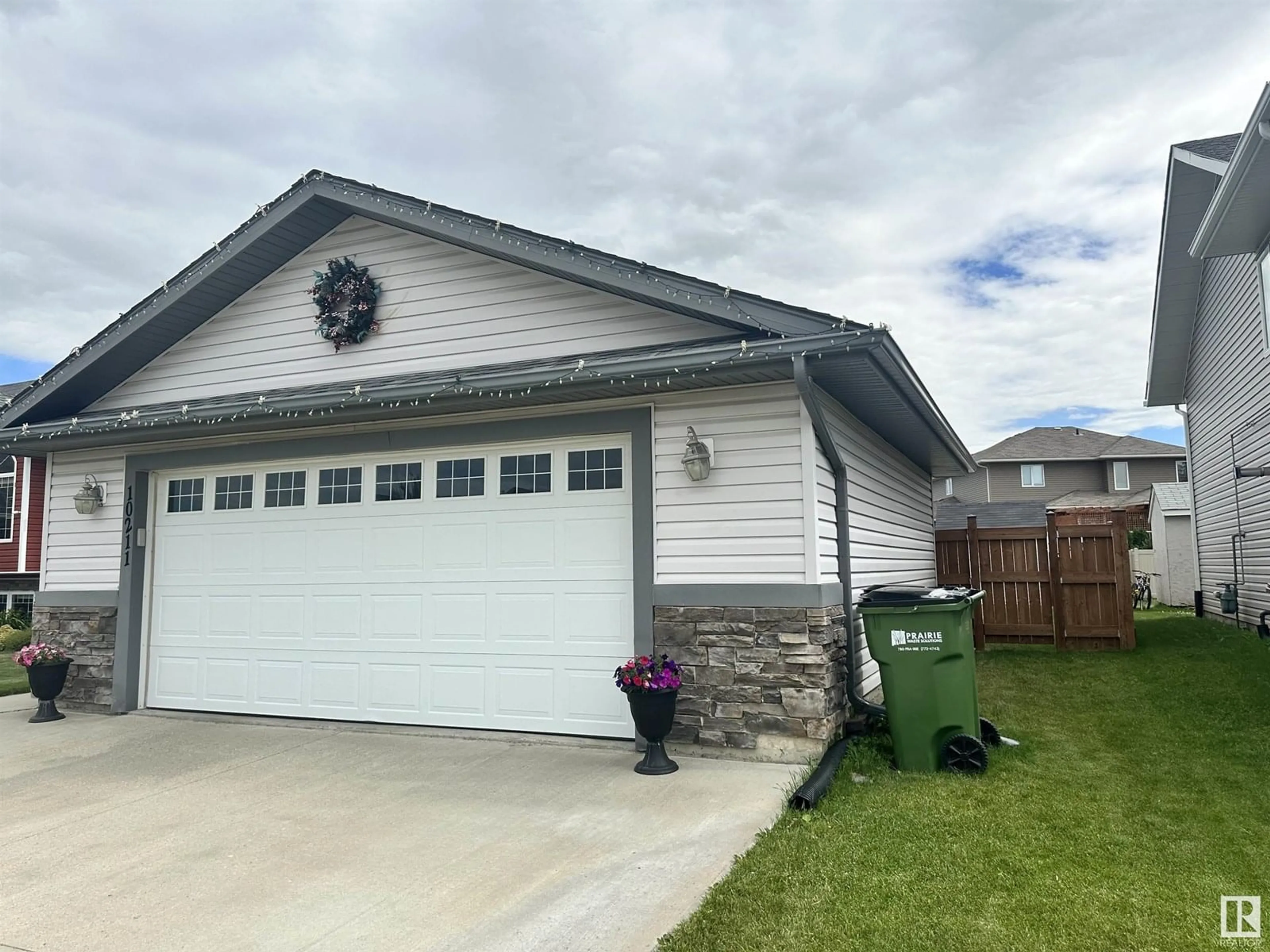 Home with vinyl exterior material, street for 10211 110 AV, Westlock Alberta T7P2S1