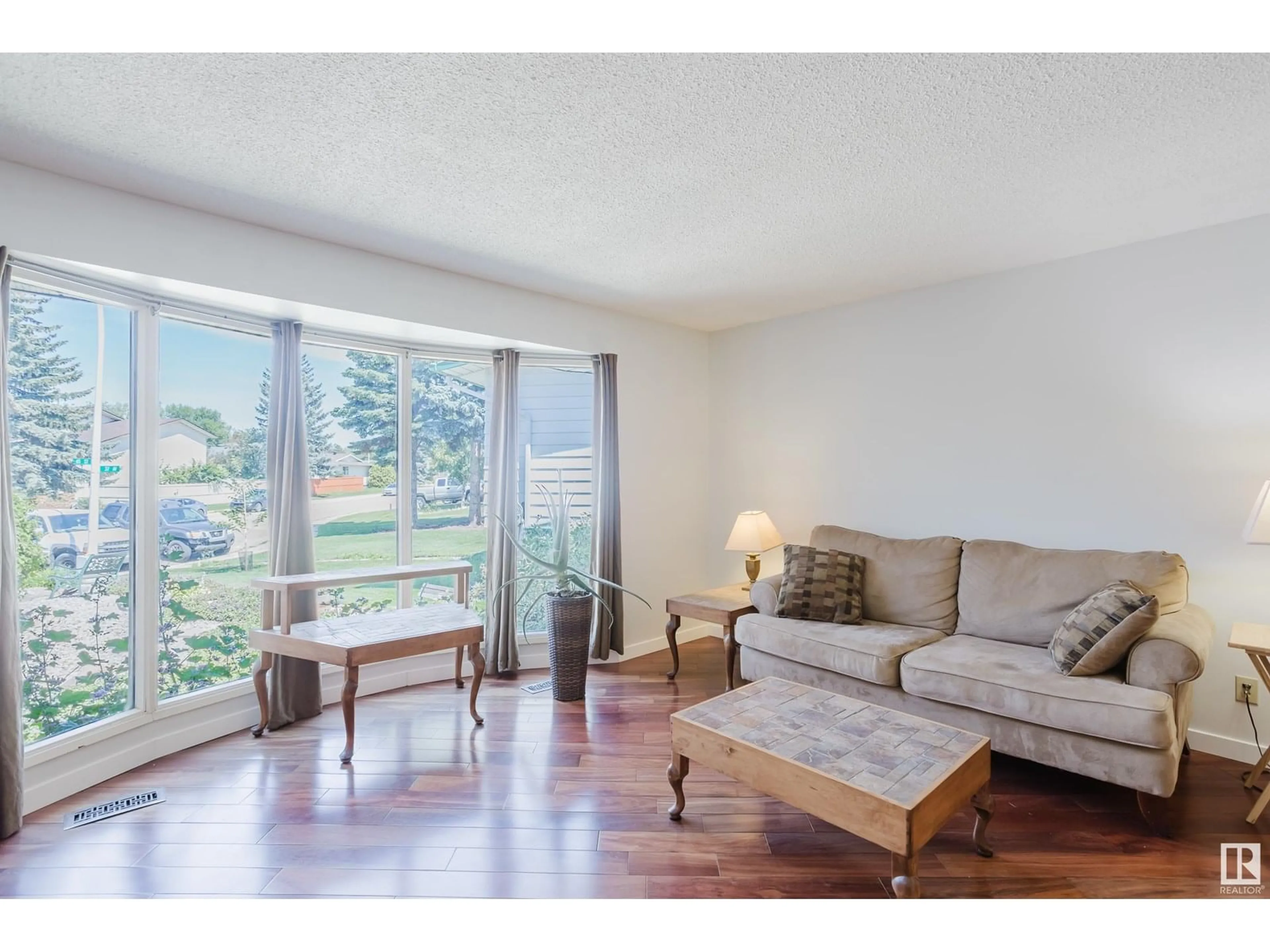 Living room with furniture, wood/laminate floor for 6427 37 AV, Edmonton Alberta T6L1H7
