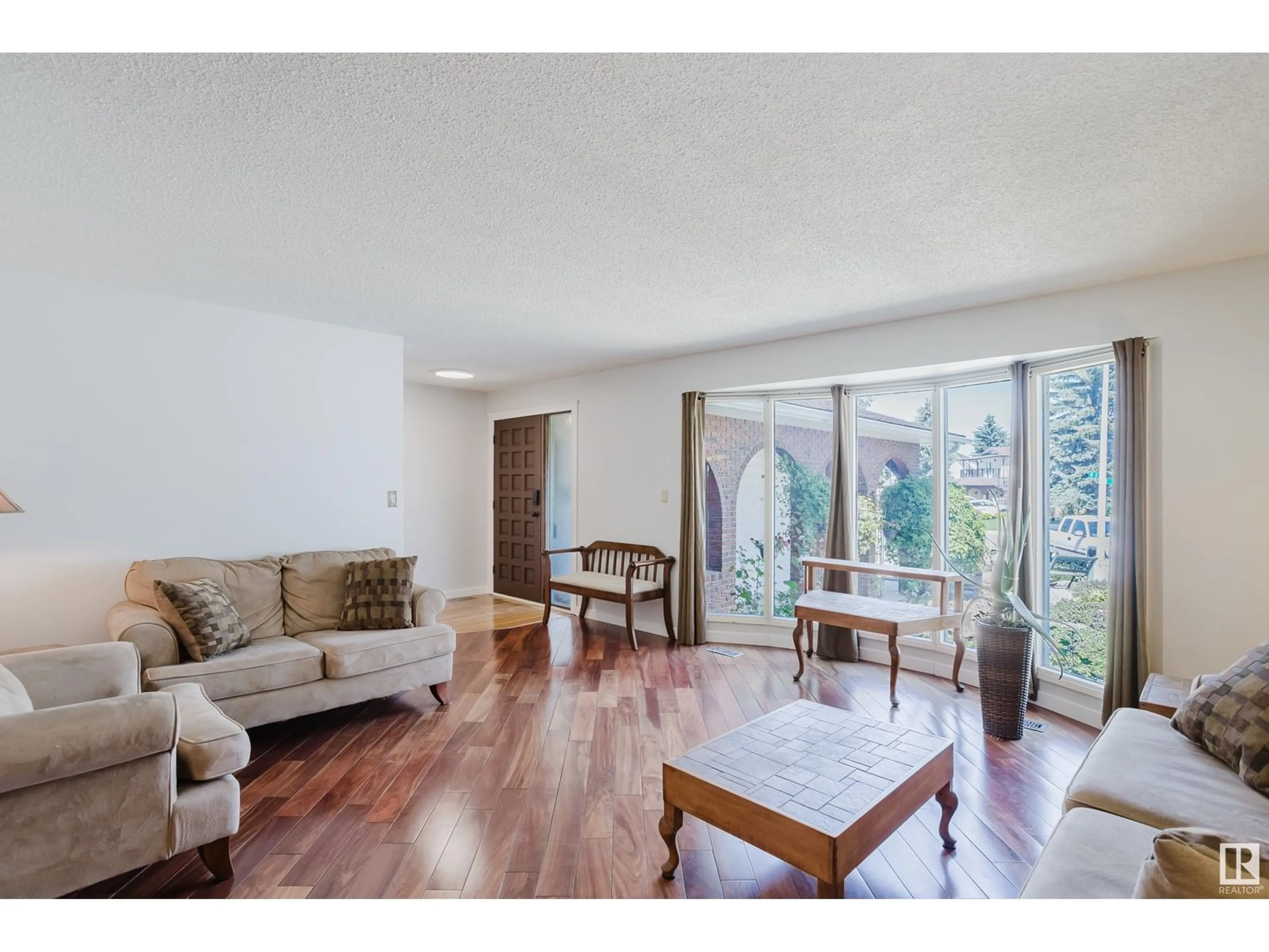 Living room with furniture, wood/laminate floor for 6427 37 AV, Edmonton Alberta T6L1H7