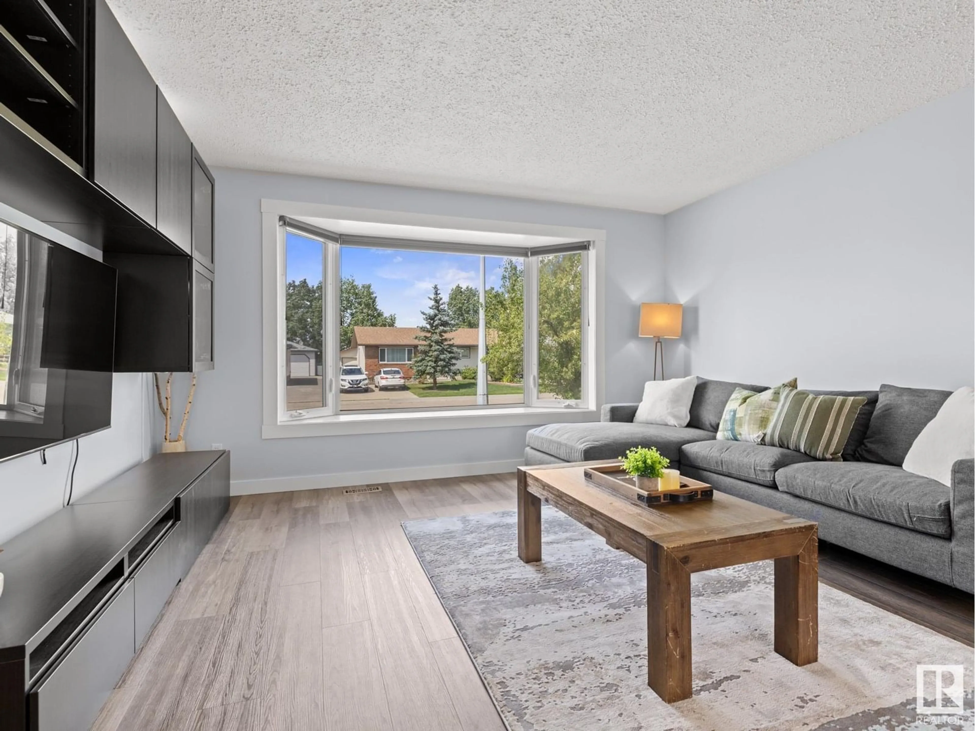 Living room with furniture, wood/laminate floor for 4301 37 AV, Leduc Alberta T9E5Z9