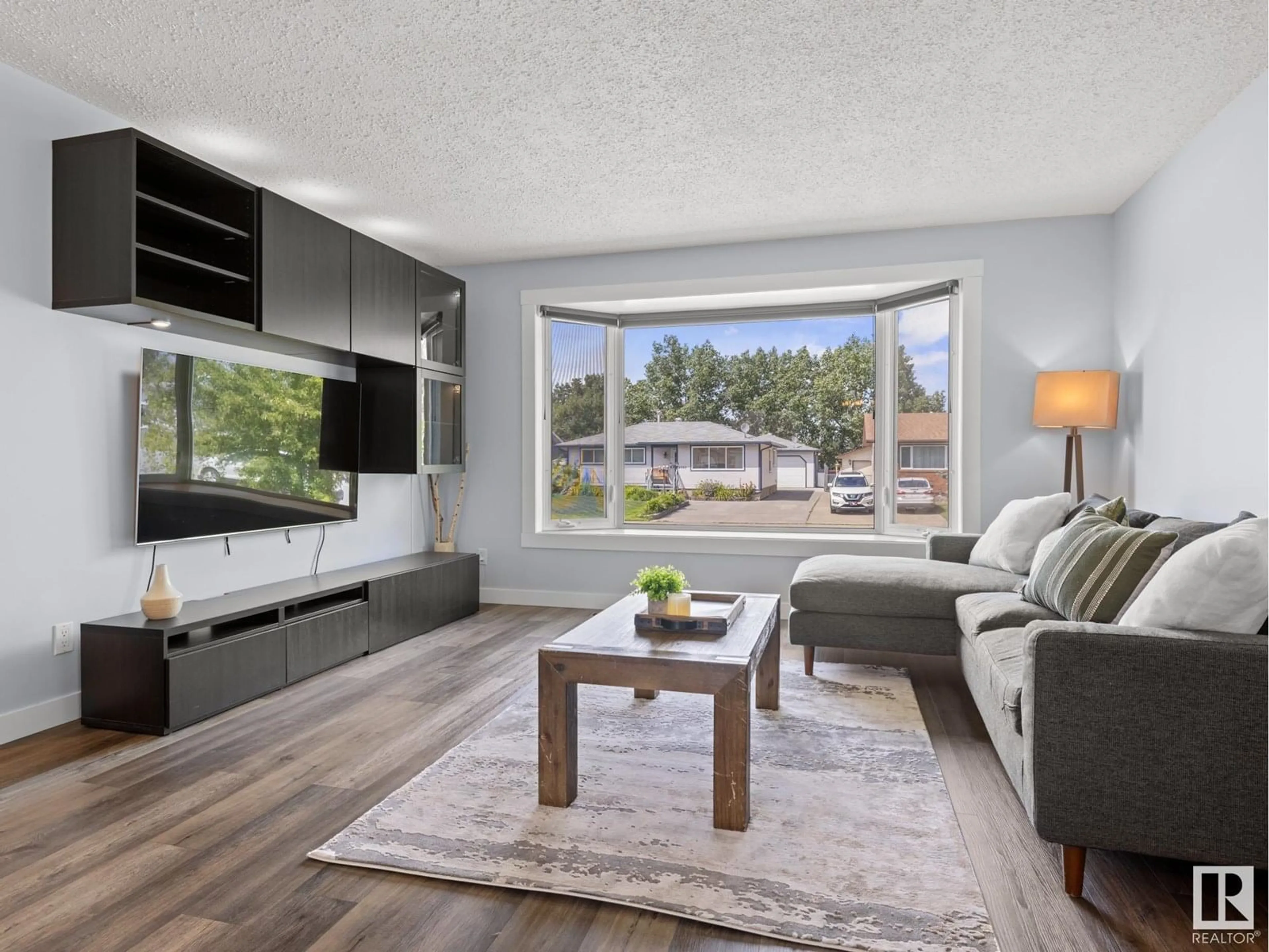 Living room with furniture, wood/laminate floor for 4301 37 AV, Leduc Alberta T9E5Z9