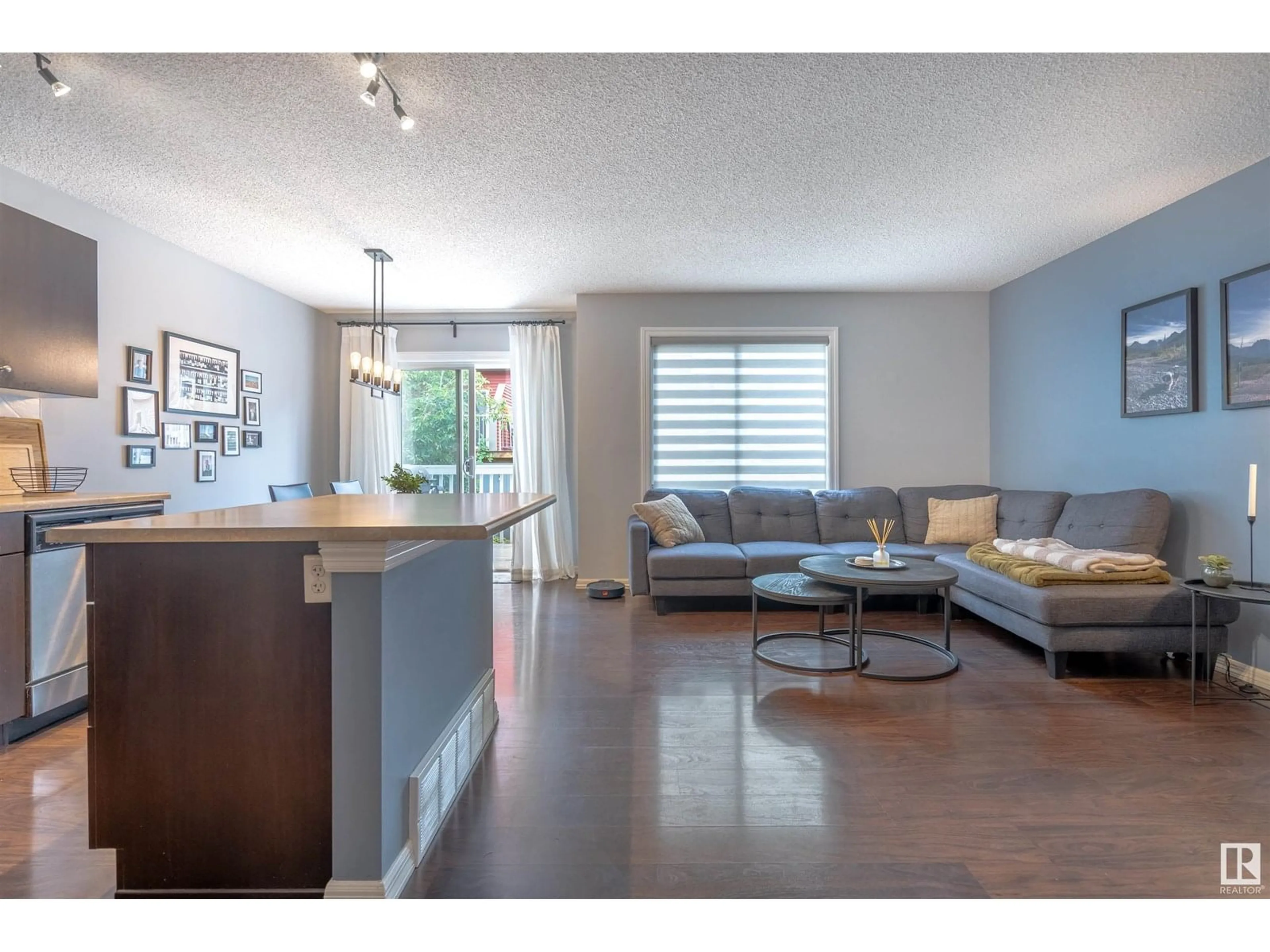 Living room with furniture, wood/laminate floor for 5101 - 22 SOLEIL BV, Beaumont Alberta T4X0E3