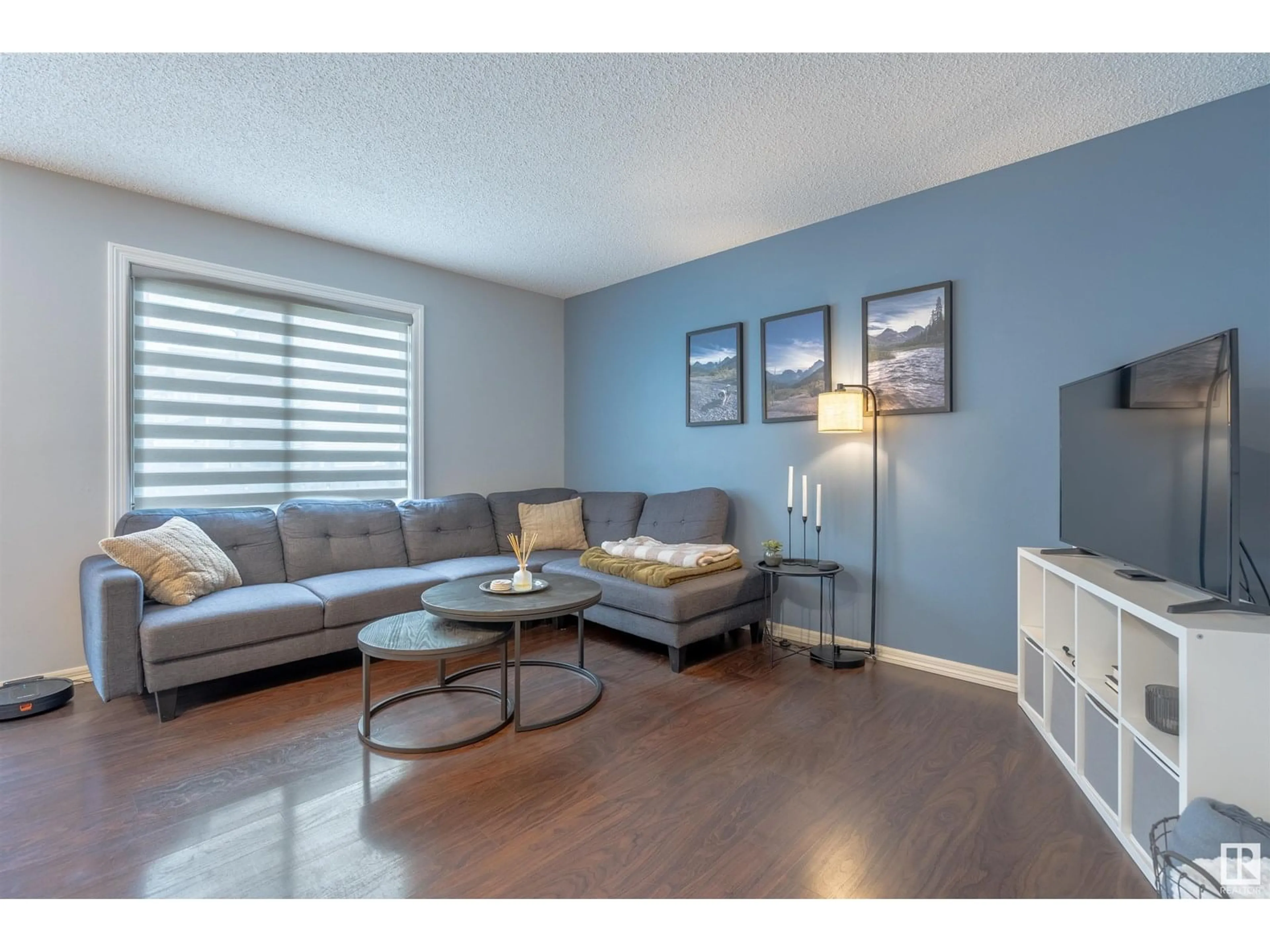 Living room with furniture, wood/laminate floor for 5101 - 22 SOLEIL BV, Beaumont Alberta T4X0E3