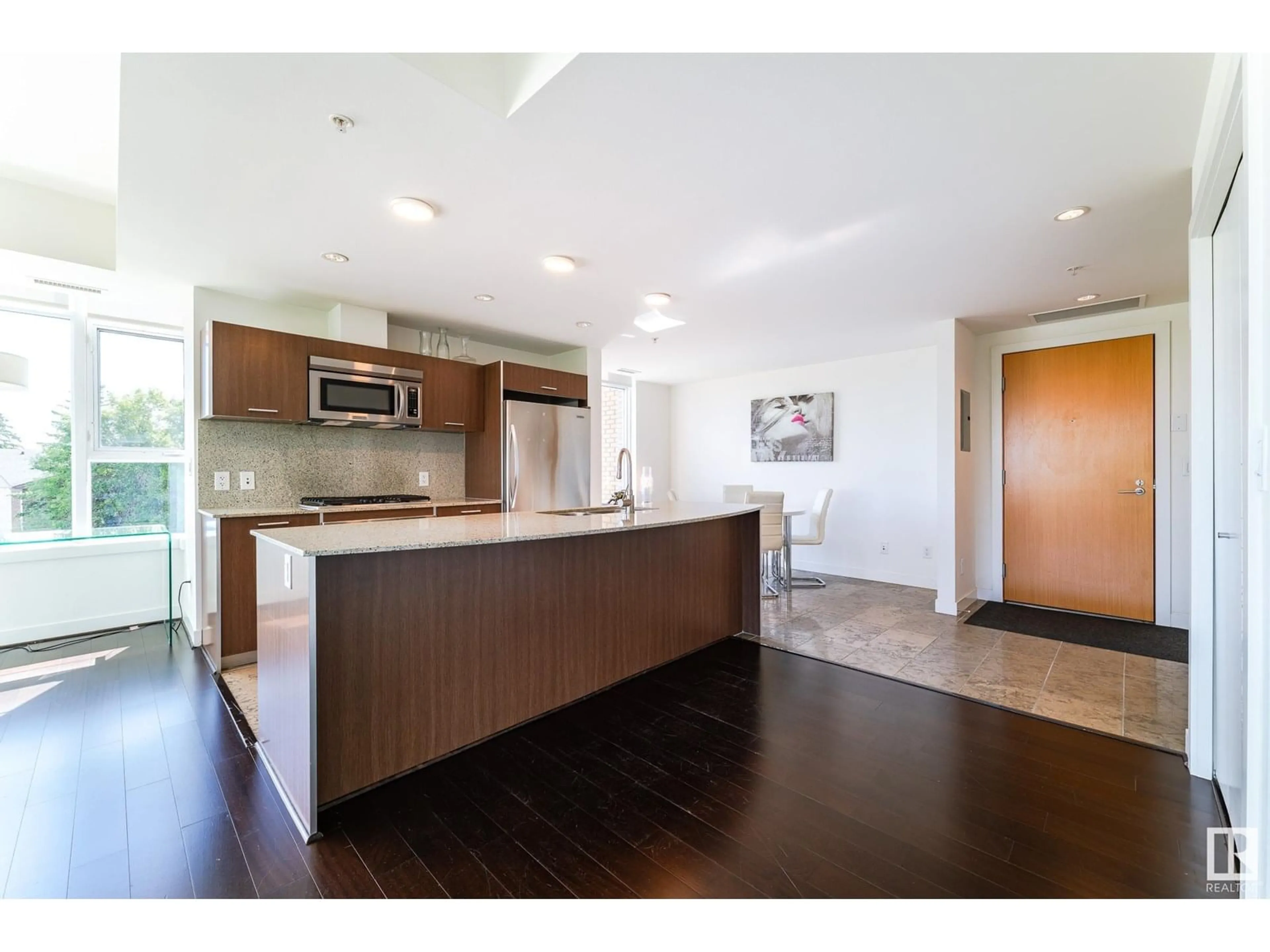 Open concept kitchen, wood/laminate floor for #306 - 2510 109 ST, Edmonton Alberta T6J2X1