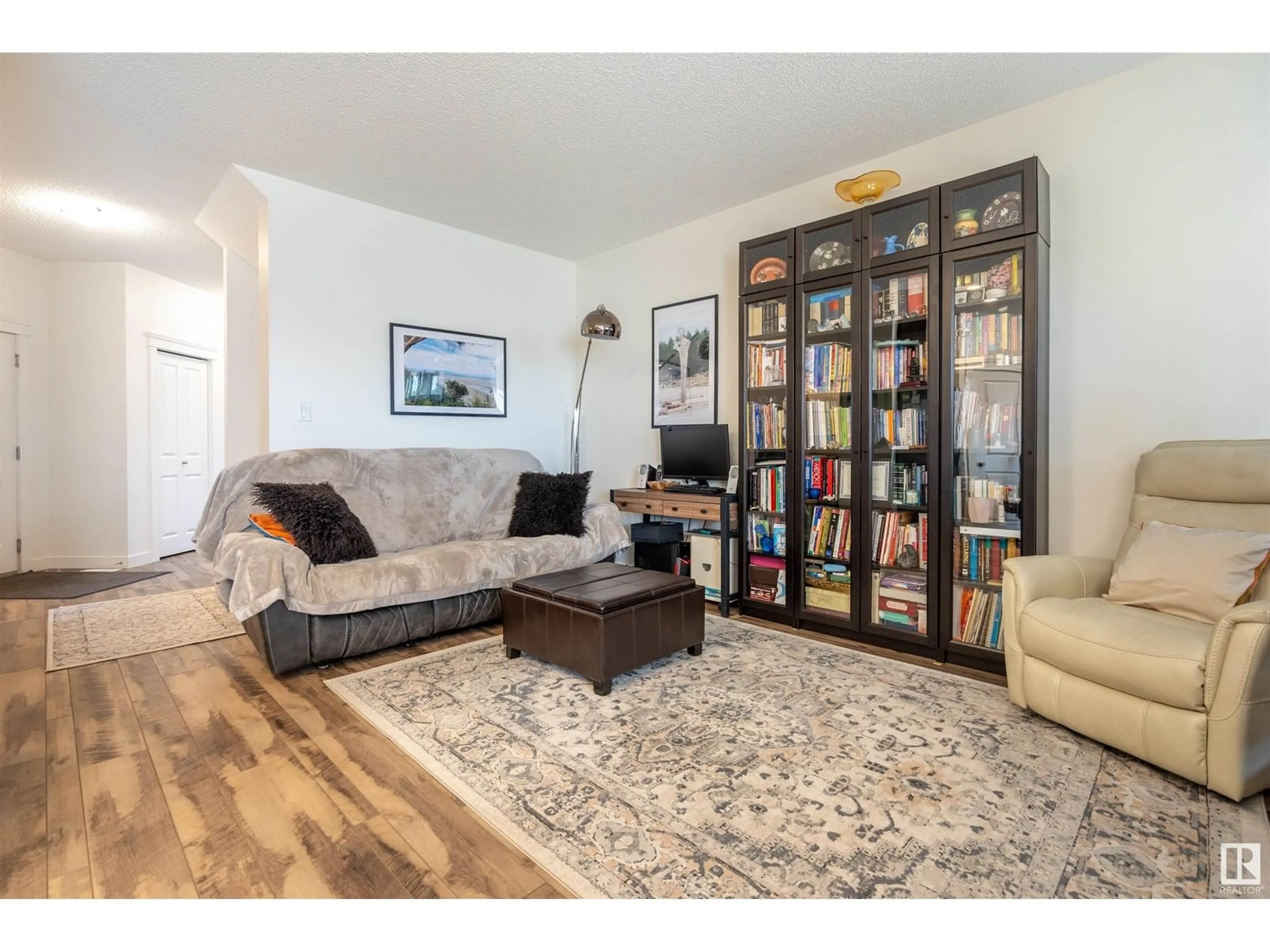 Living room with furniture, wood/laminate floor for 2066 GRAYDON HILL CR, Edmonton Alberta T6W2W9