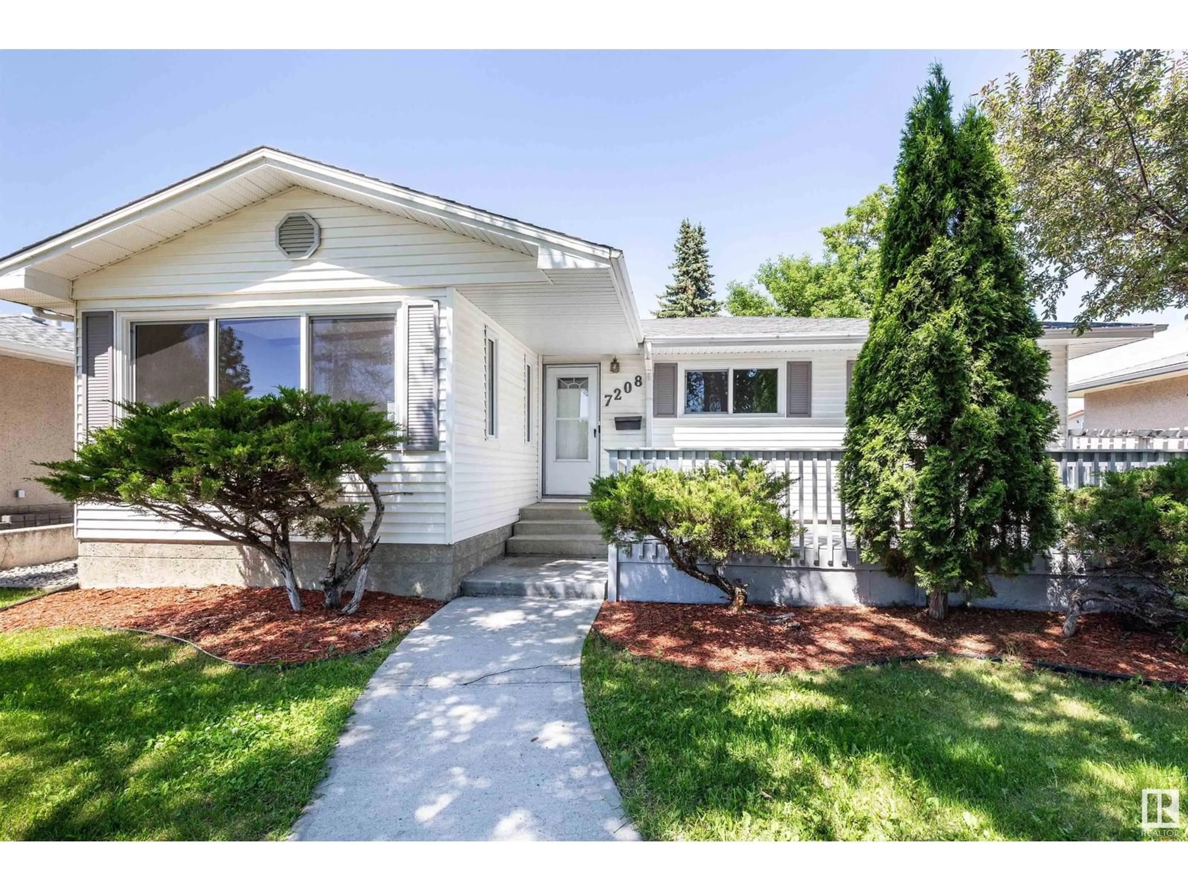 Home with vinyl exterior material, street for 7208 137 AV, Edmonton Alberta T5C2L5