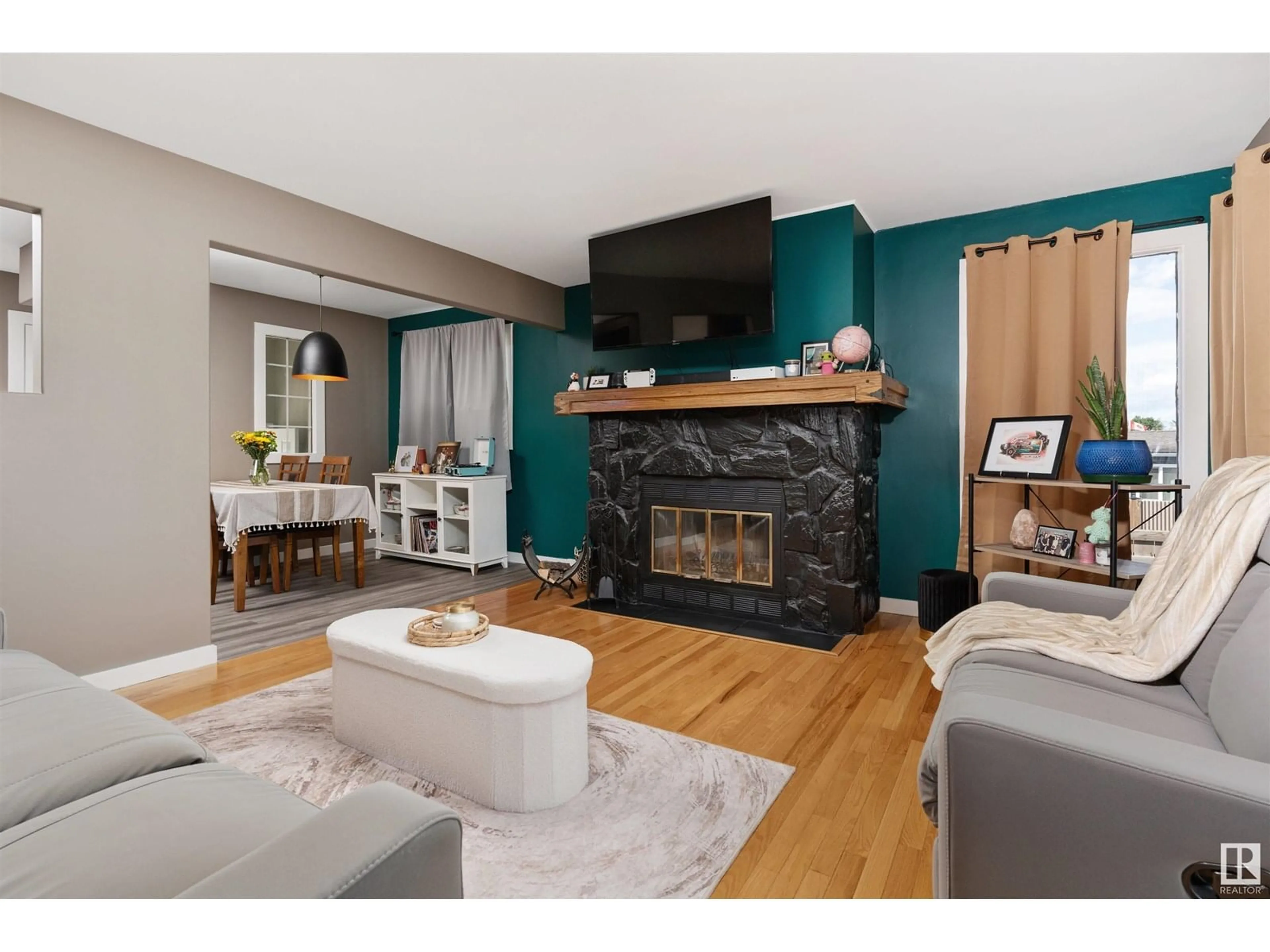 Living room with furniture, wood/laminate floor for 5422 51 ST, Camrose Alberta T4V3C6