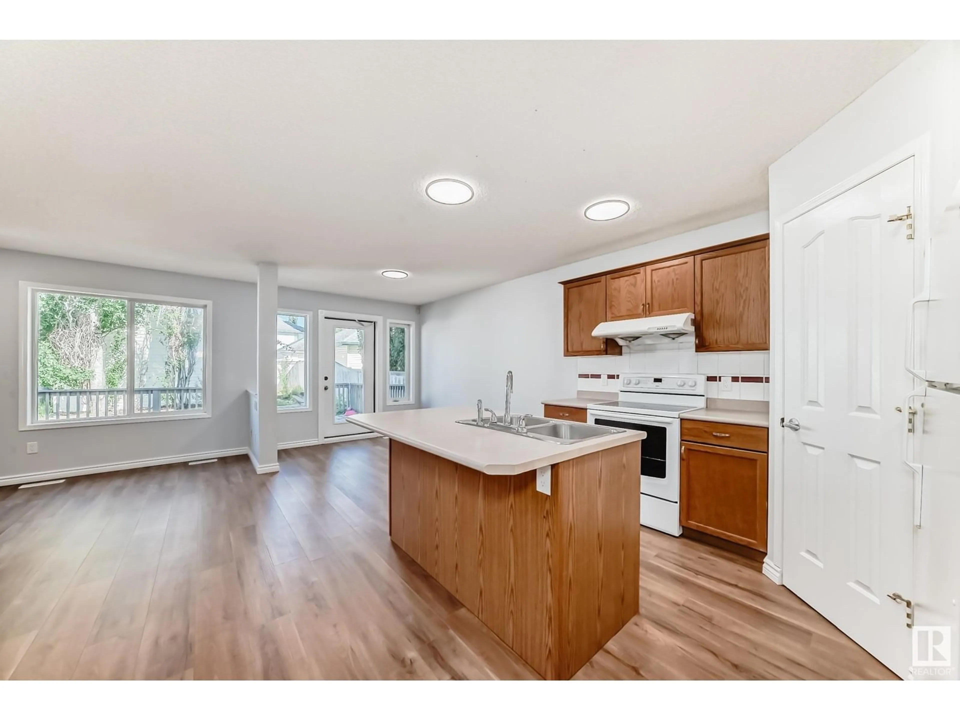 Open concept kitchen, wood/laminate floor for 1846 TOMLINSON CR, Edmonton Alberta T6R2T5