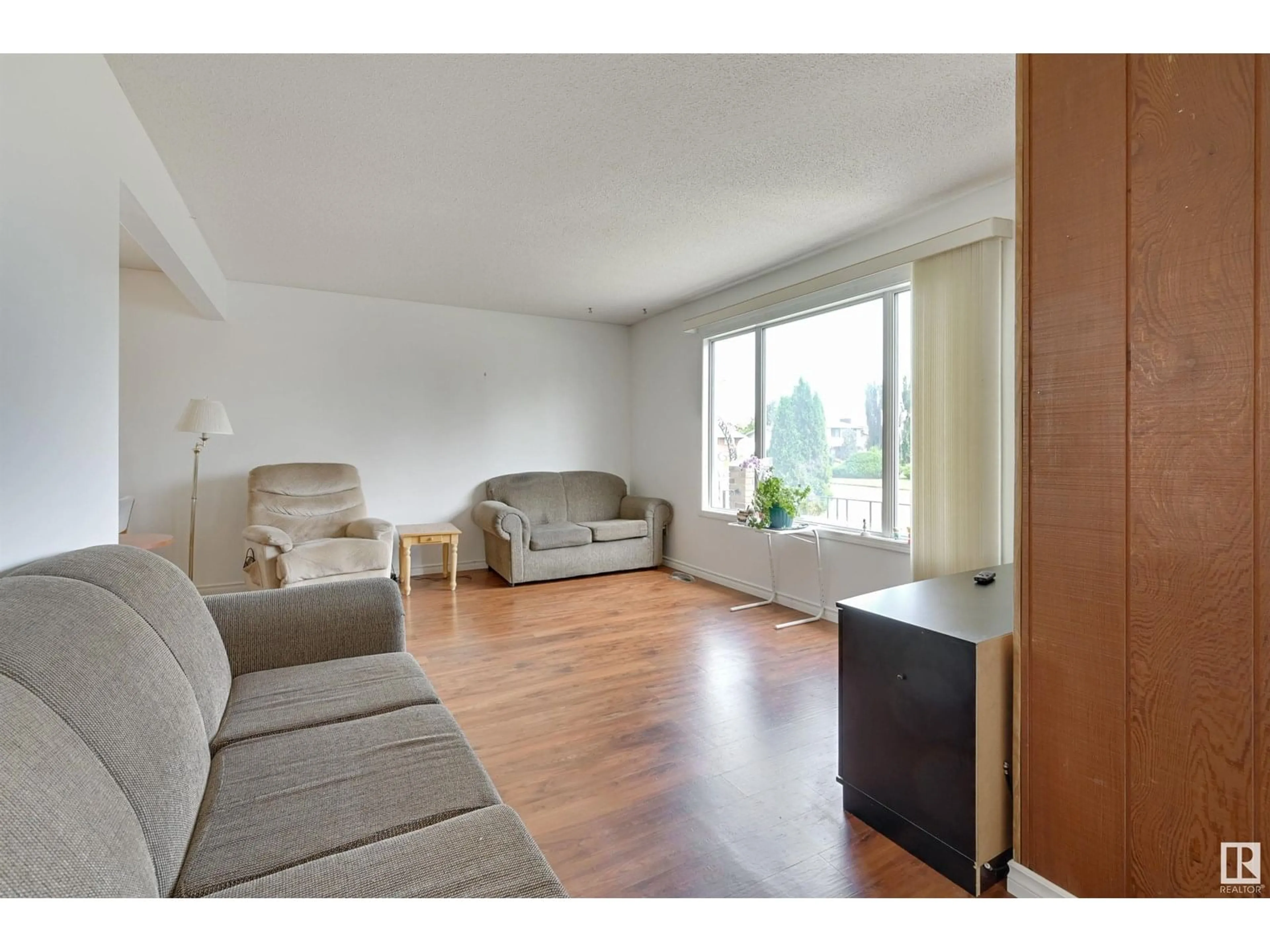 Living room with furniture, wood/laminate floor for NW - 15008 96 ST, Edmonton Alberta T5E4W7