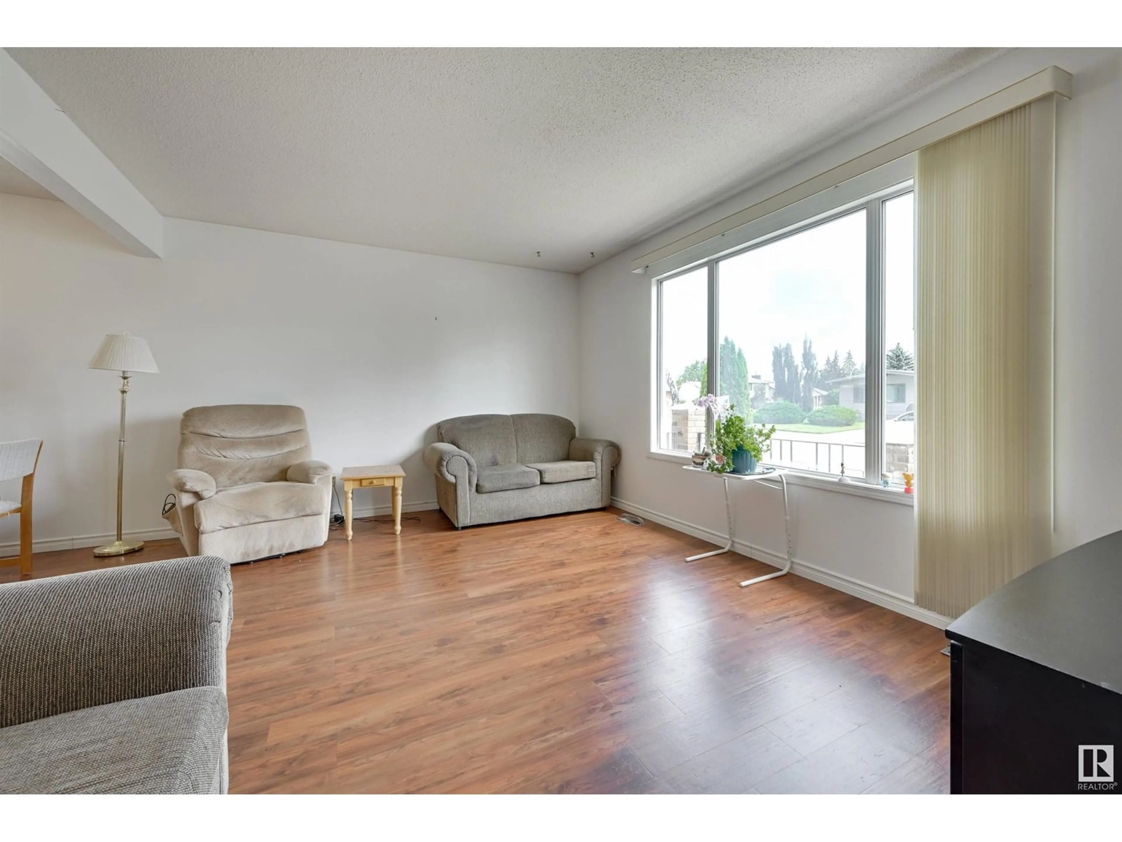 Living room with furniture, wood/laminate floor for NW - 15008 96 ST, Edmonton Alberta T5E4W7