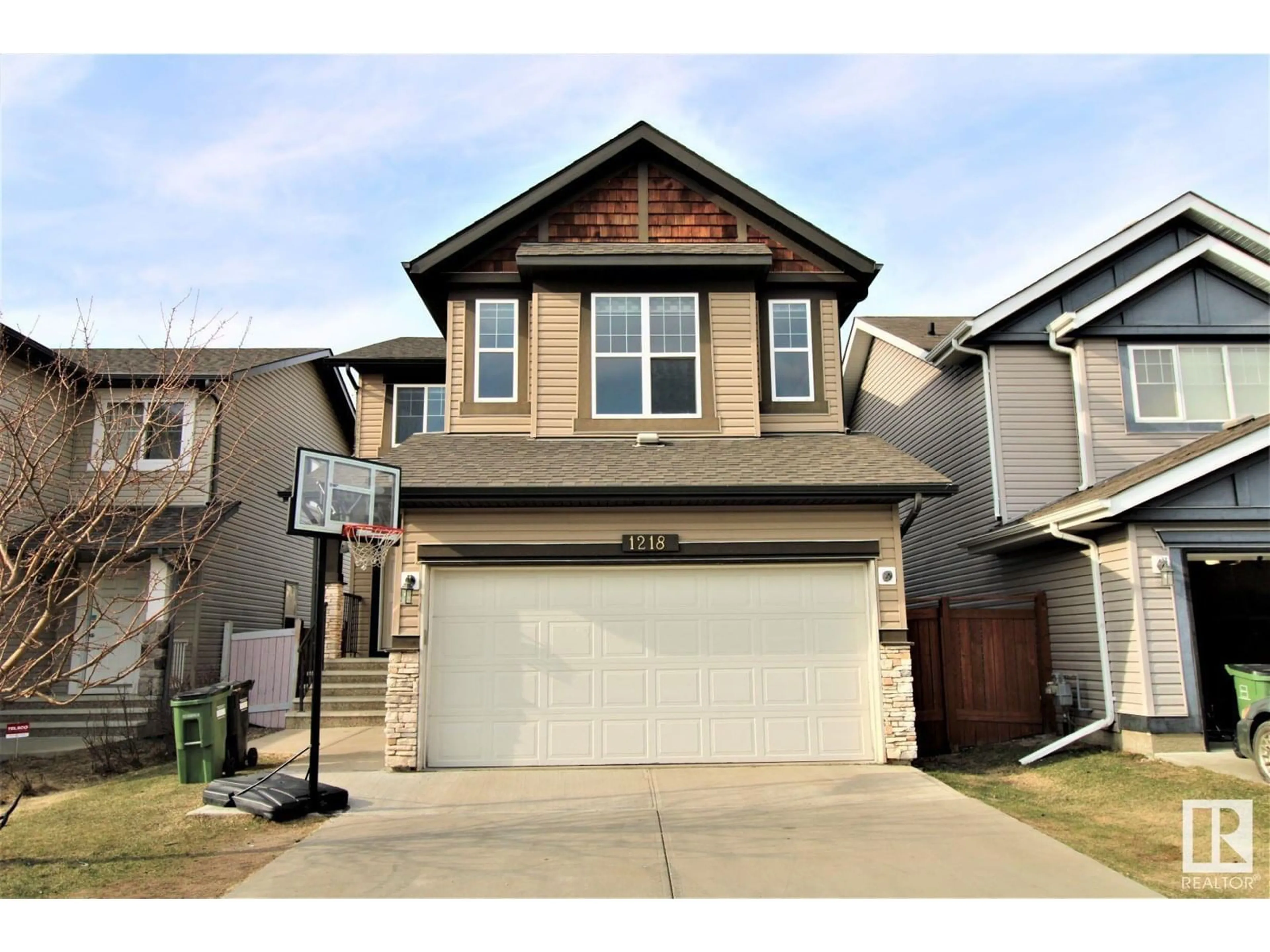 Home with vinyl exterior material, street for 1218 37 AV NW, Edmonton Alberta T6T0J5
