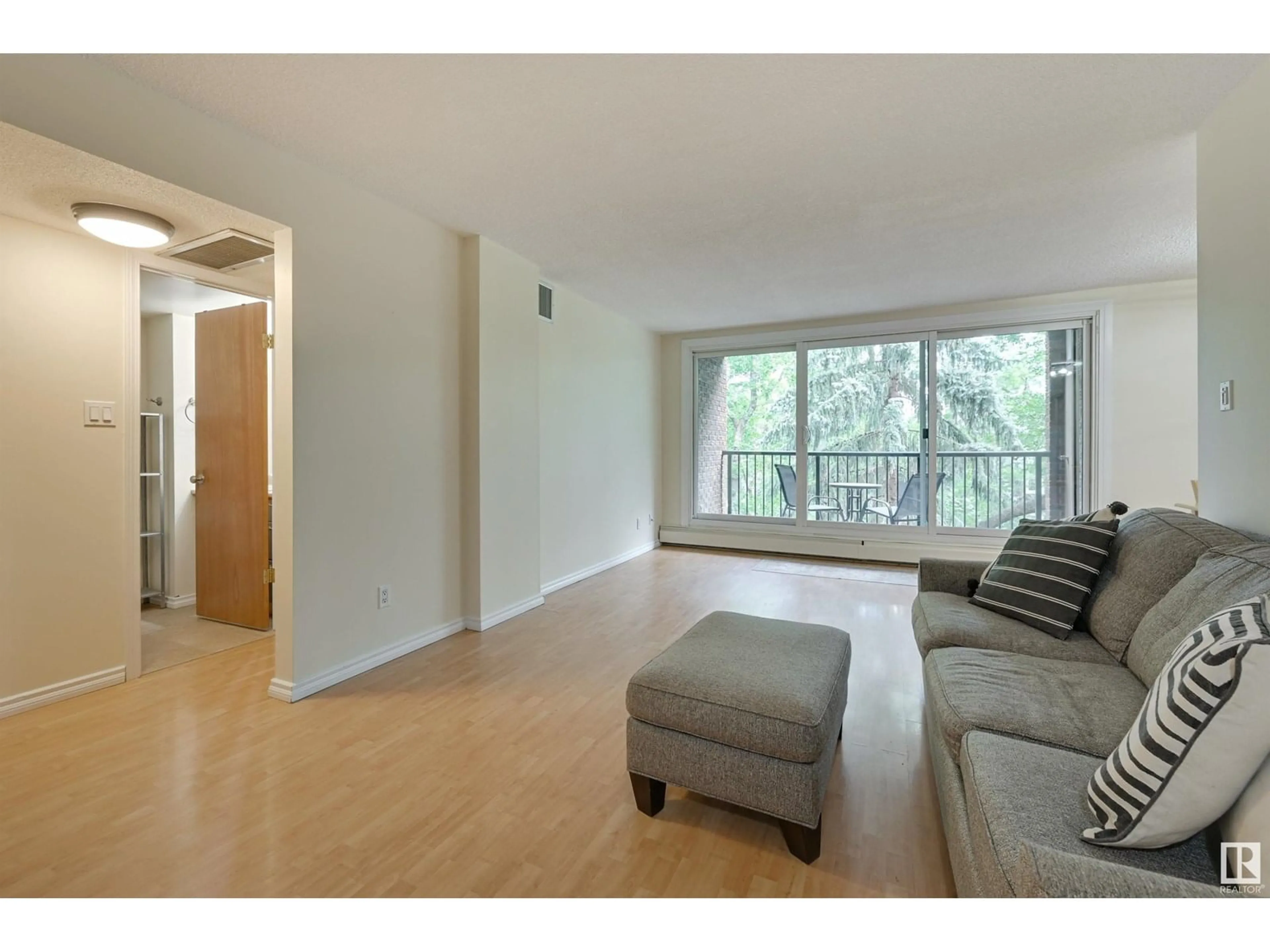 Living room with furniture, wood/laminate floor for 407 - 11011 86 AV, Edmonton Alberta T6G0X1