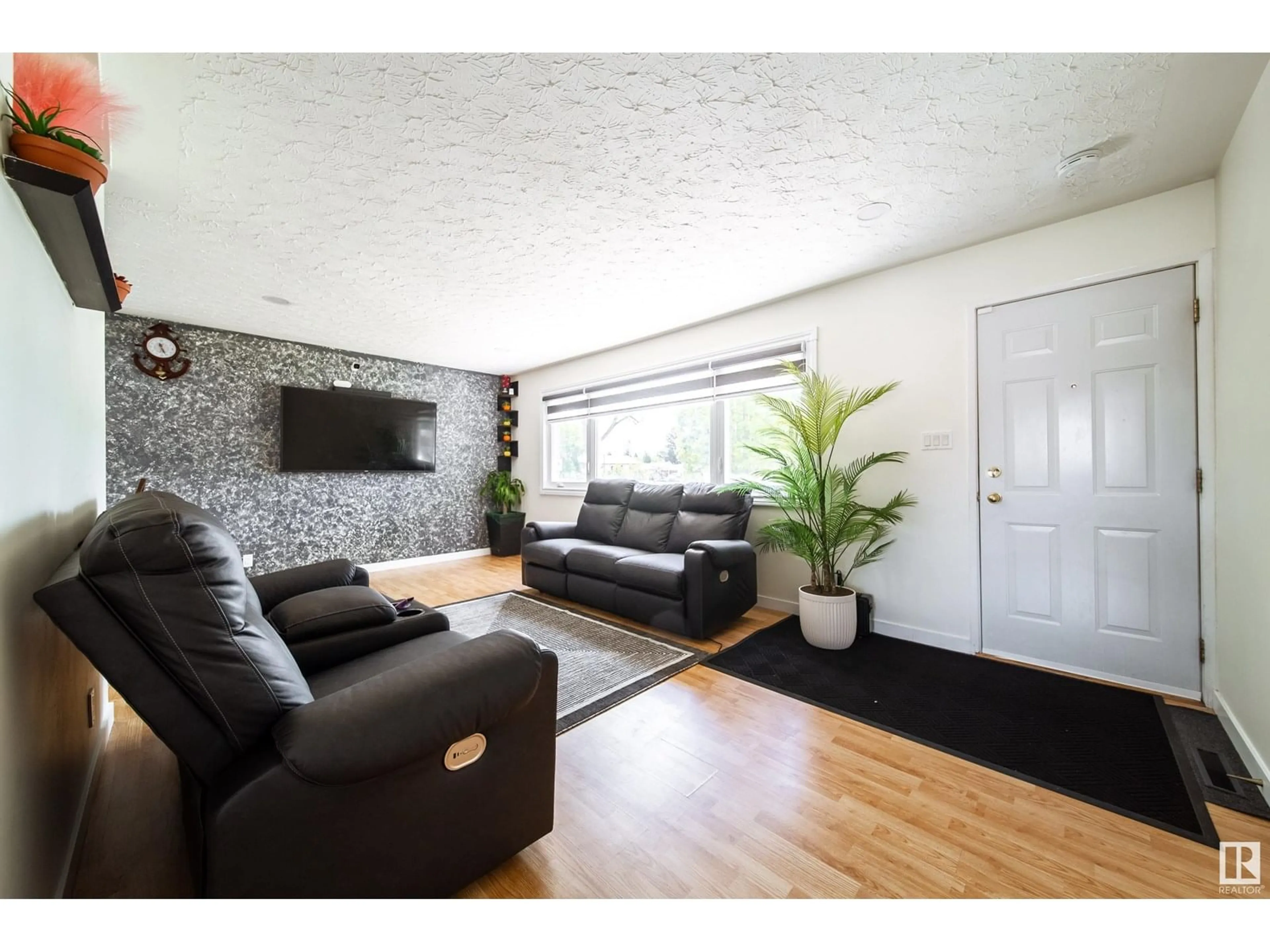 Living room with furniture, wood/laminate floor for 15906 92 AV, Edmonton Alberta T5R5C6