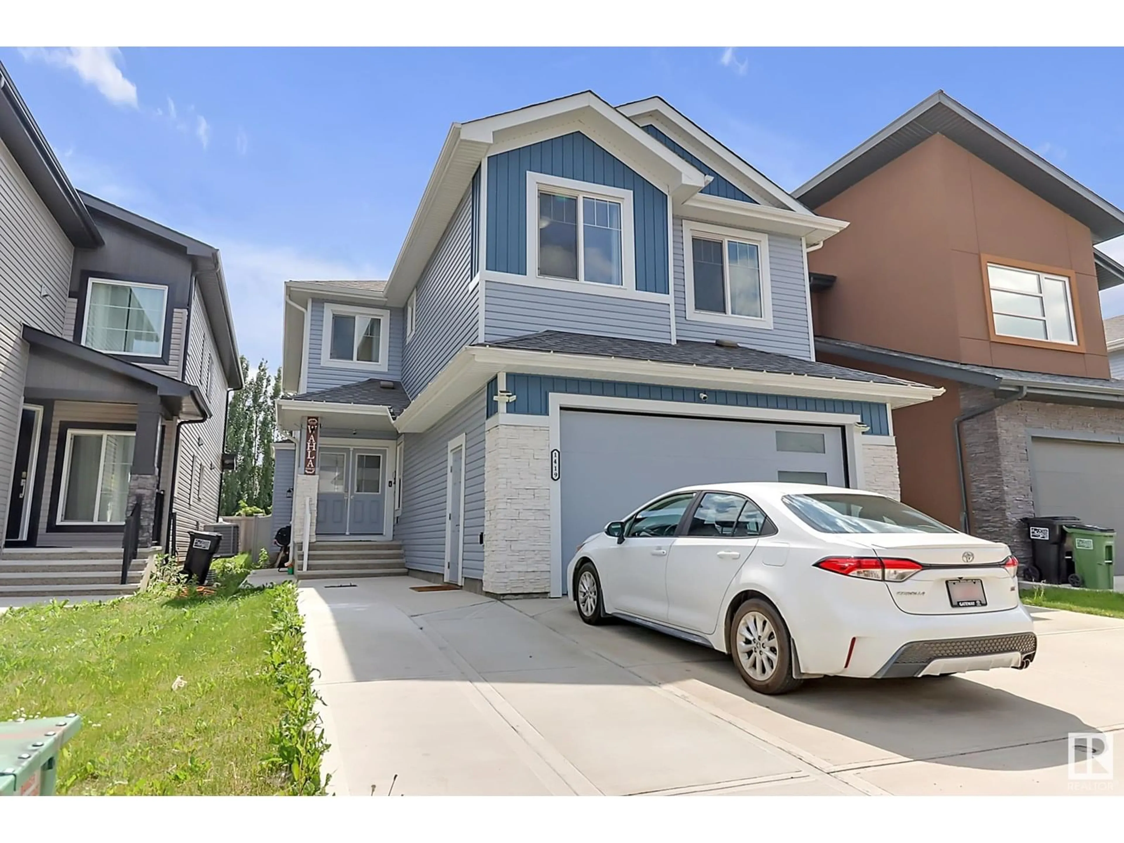 Home with vinyl exterior material, street for NW - 1419 150 AV, Edmonton Alberta T5Y3R5