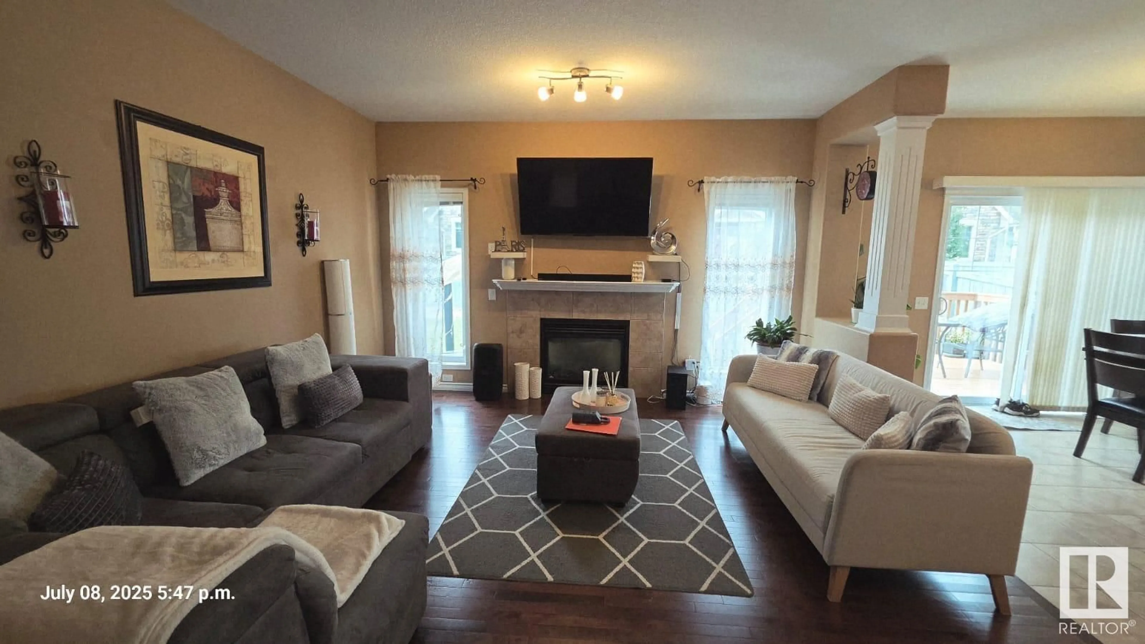 Living room with furniture, wood/laminate floor for NW - 5936 209 ST, Edmonton Alberta T6M0L1