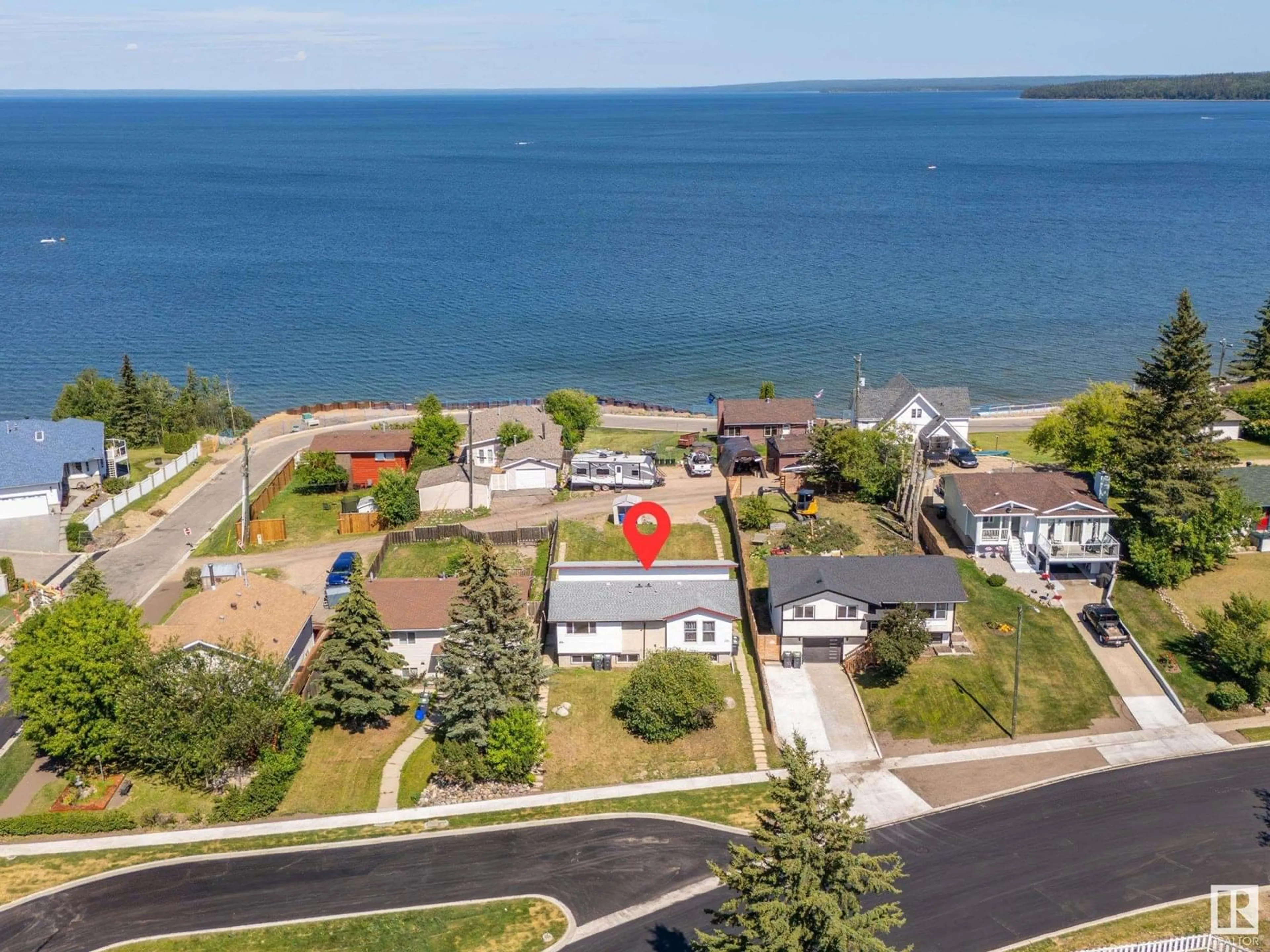 A pic from outside/outdoor area/front of a property/back of a property/a pic from drone, water/lake/river/ocean view for 206 10 ST, Cold Lake Alberta T9M1A5