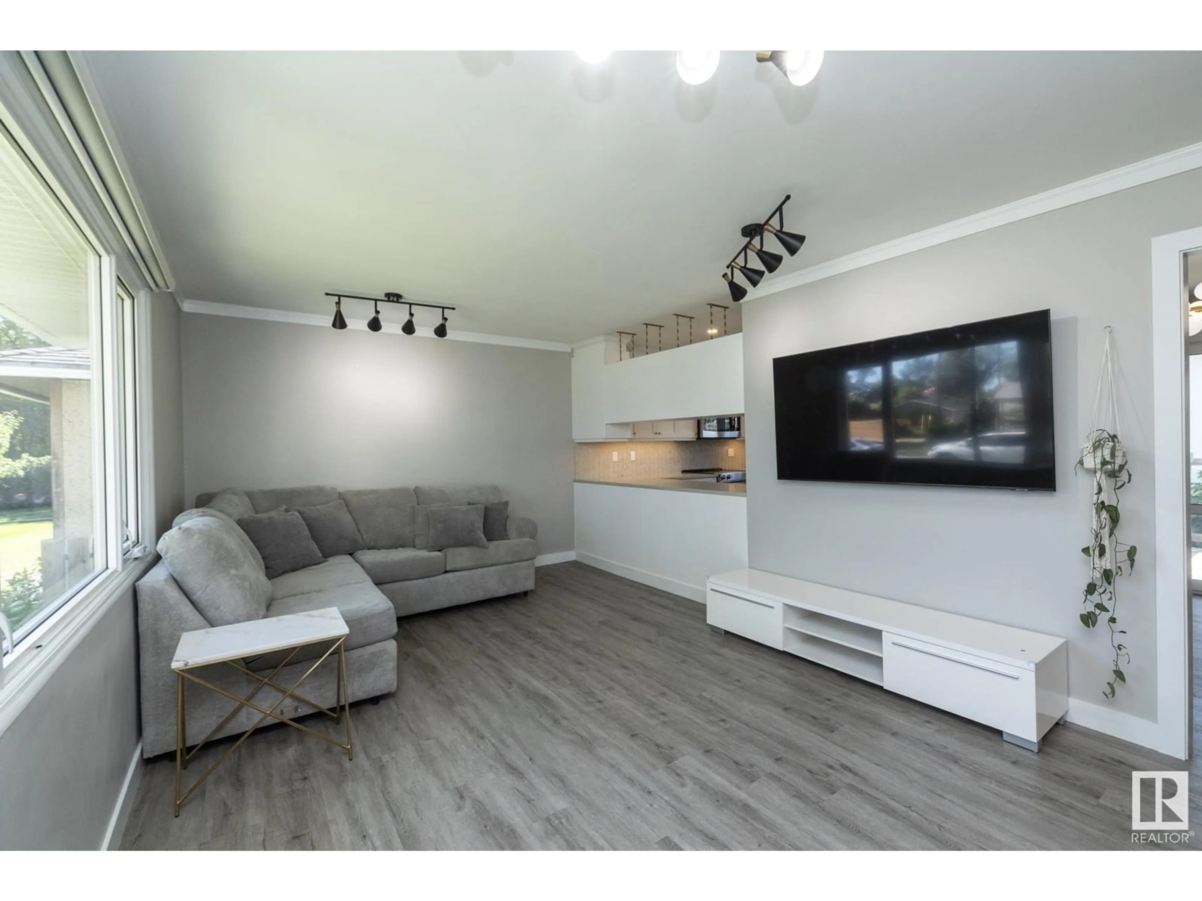 Living room with furniture, wood/laminate floor for 13519 124 AV, Edmonton Alberta T5L3A7
