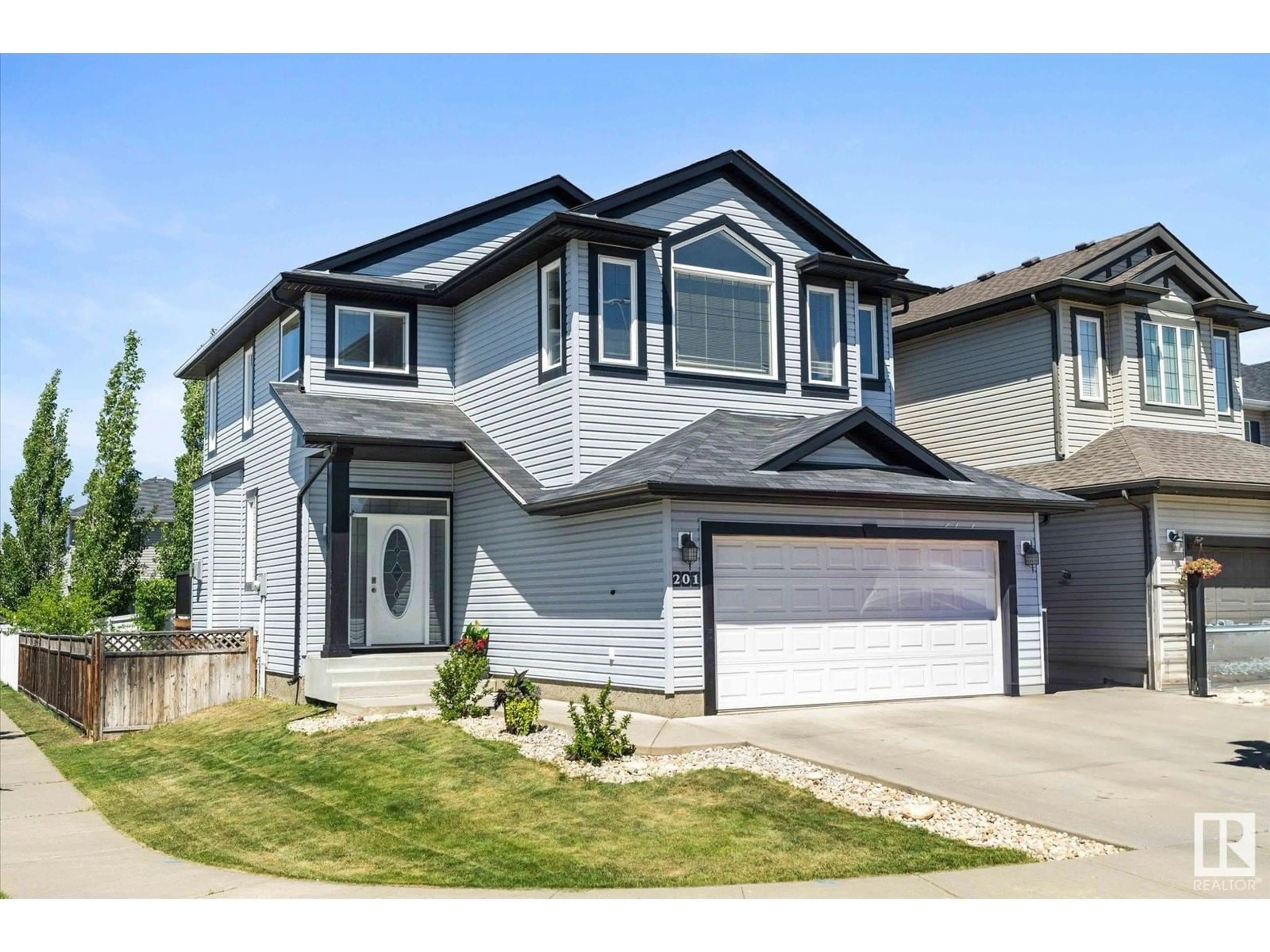 Home with vinyl exterior material, street for 201 WOODBEND WY, Fort Saskatchewan Alberta T8L0B8
