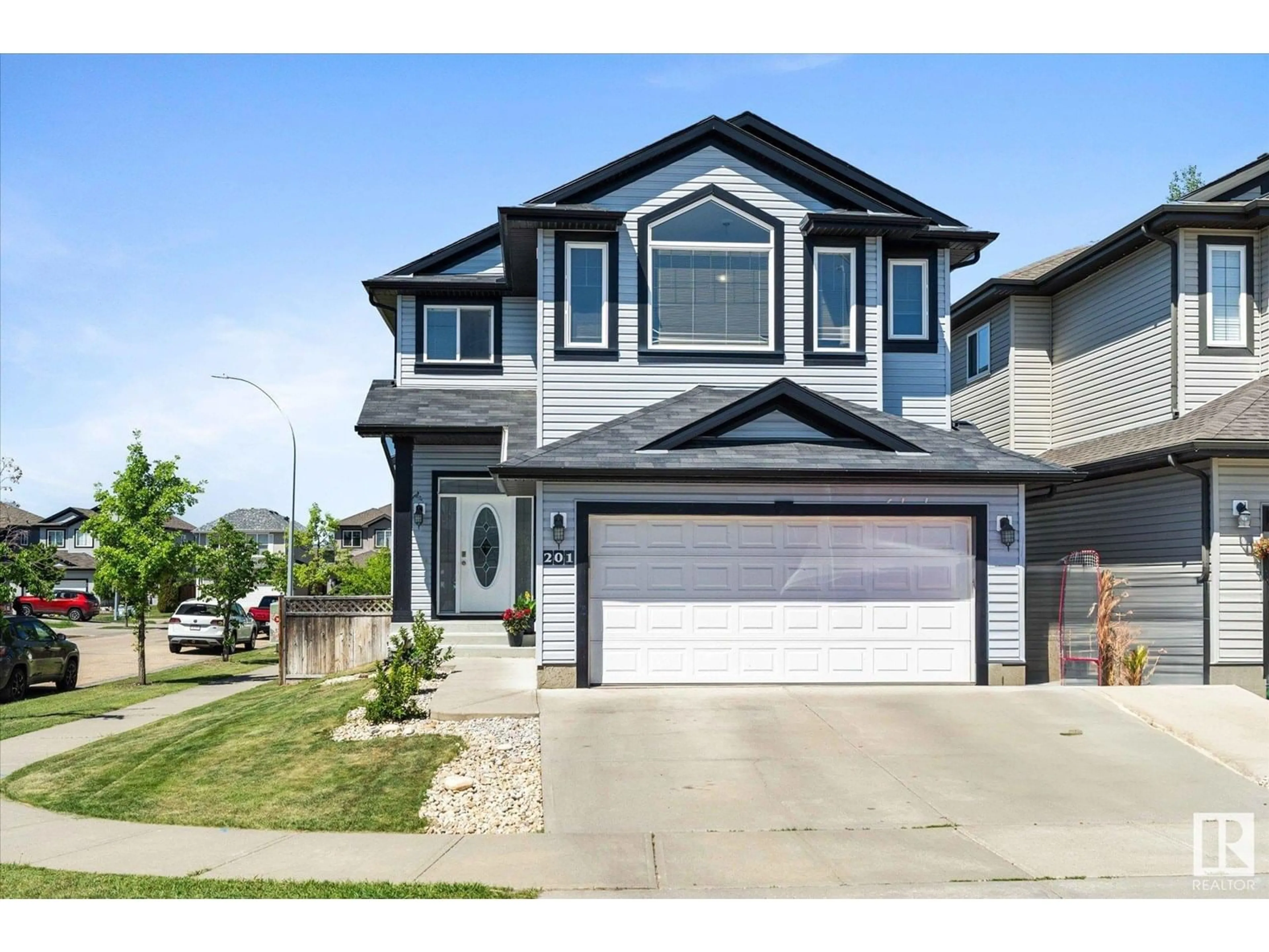 Home with vinyl exterior material, street for 201 WOODBEND WY, Fort Saskatchewan Alberta T8L0B8