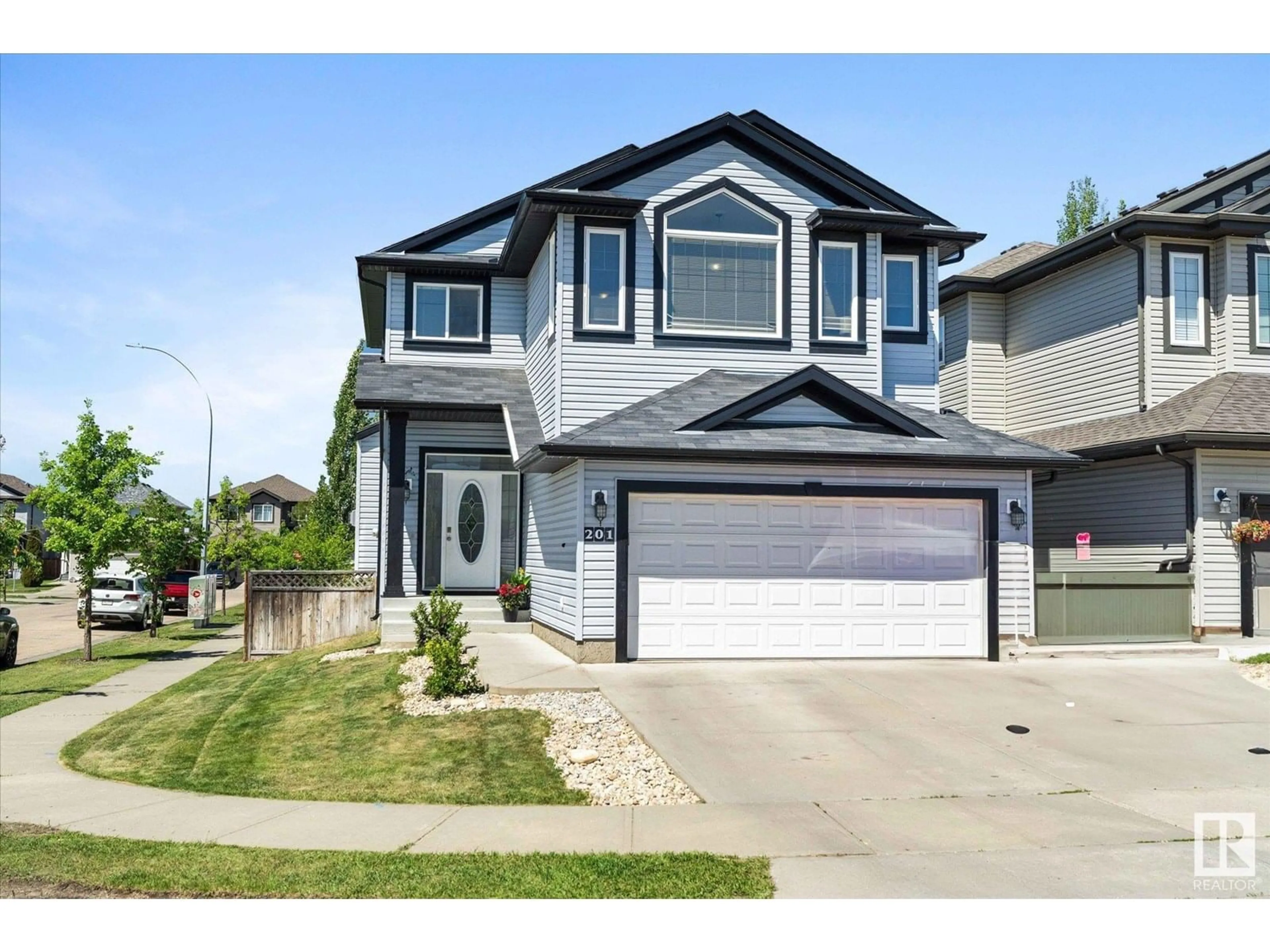 Home with vinyl exterior material, street for 201 WOODBEND WY, Fort Saskatchewan Alberta T8L0B8