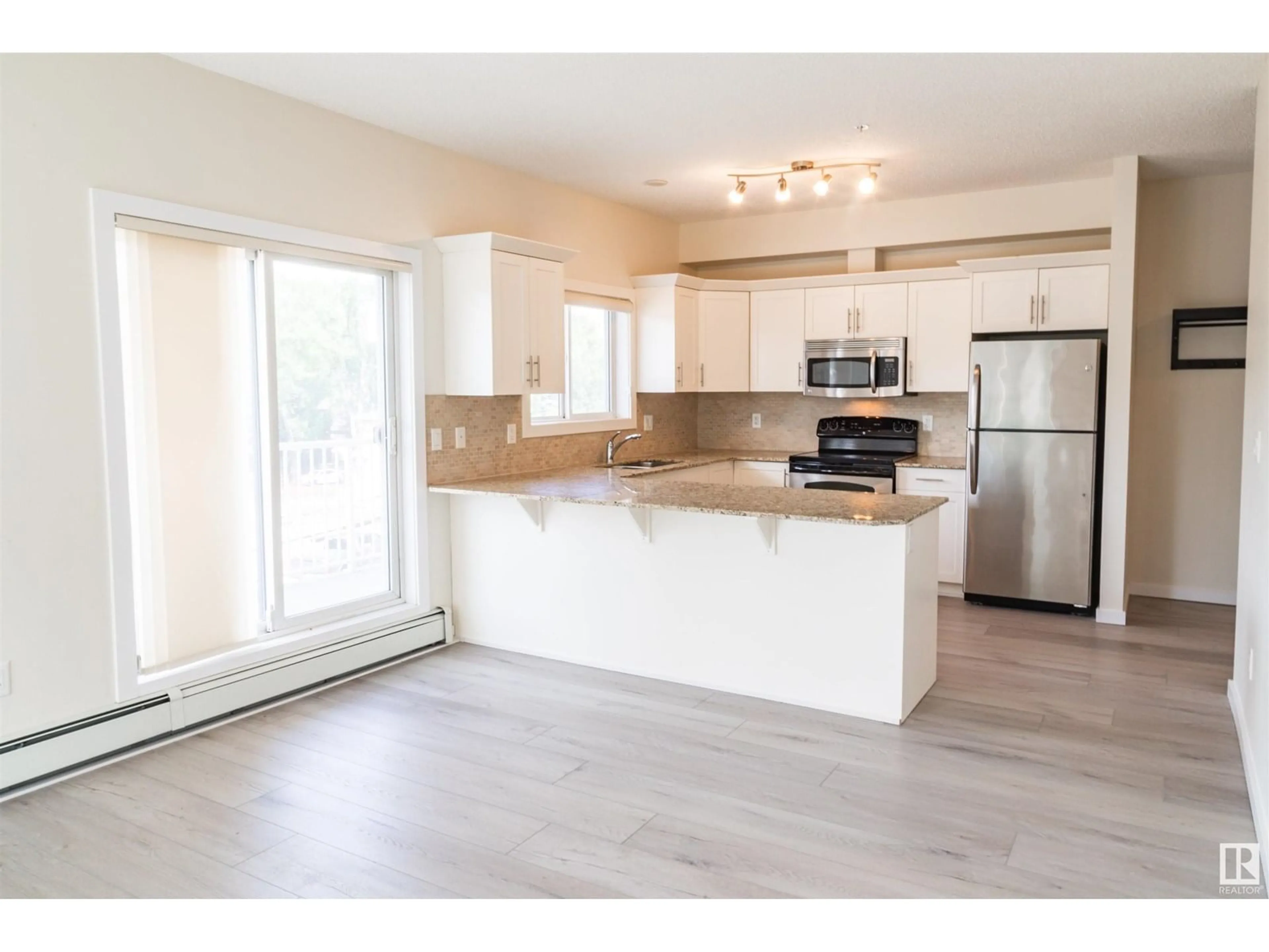 Open concept kitchen, wood/laminate floor for 304 - 10524 77 AV, Edmonton Alberta T6E1N1