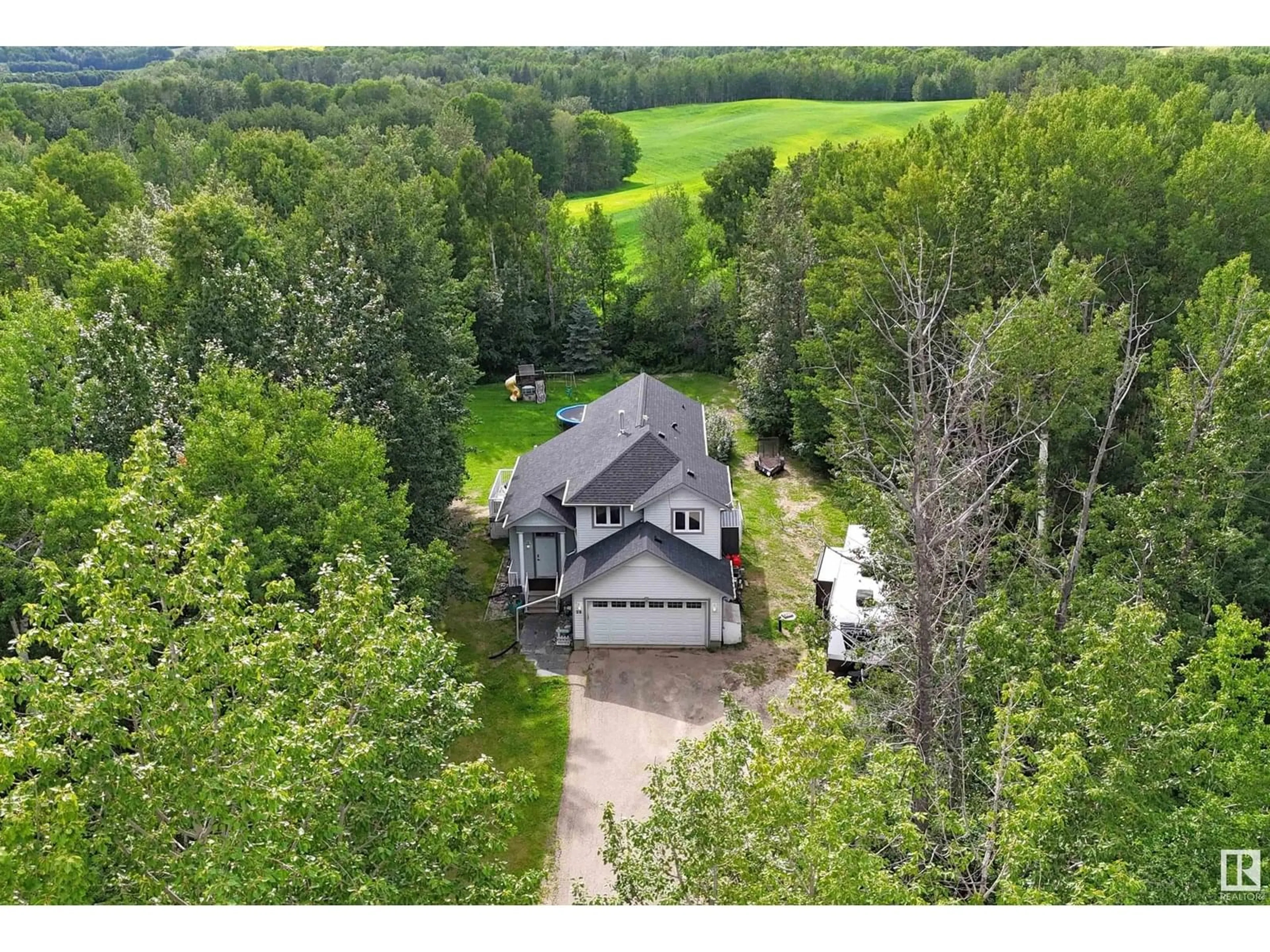 A pic from outside/outdoor area/front of a property/back of a property/a pic from drone, forest/trees view for 25 - 1307 TWP ROAD 540, Rural Parkland County Alberta T7Y0A7