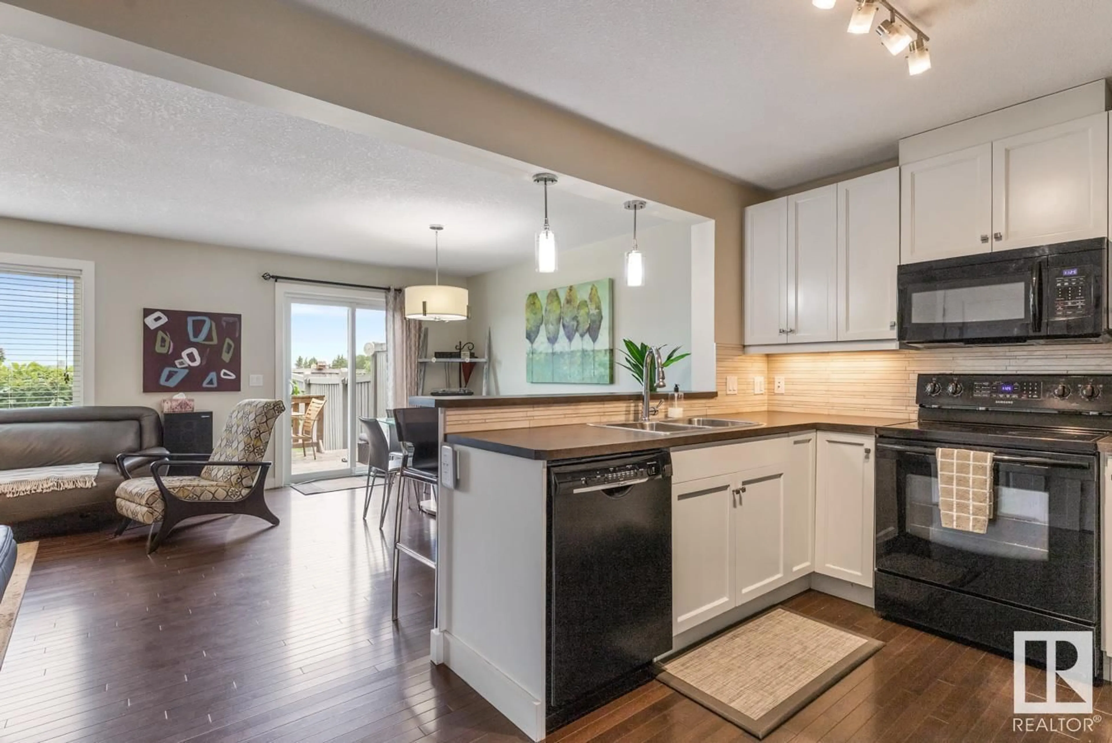 Open concept kitchen, wood/laminate floor for SW - 1058 177A ST, Edmonton Alberta T6W2A1