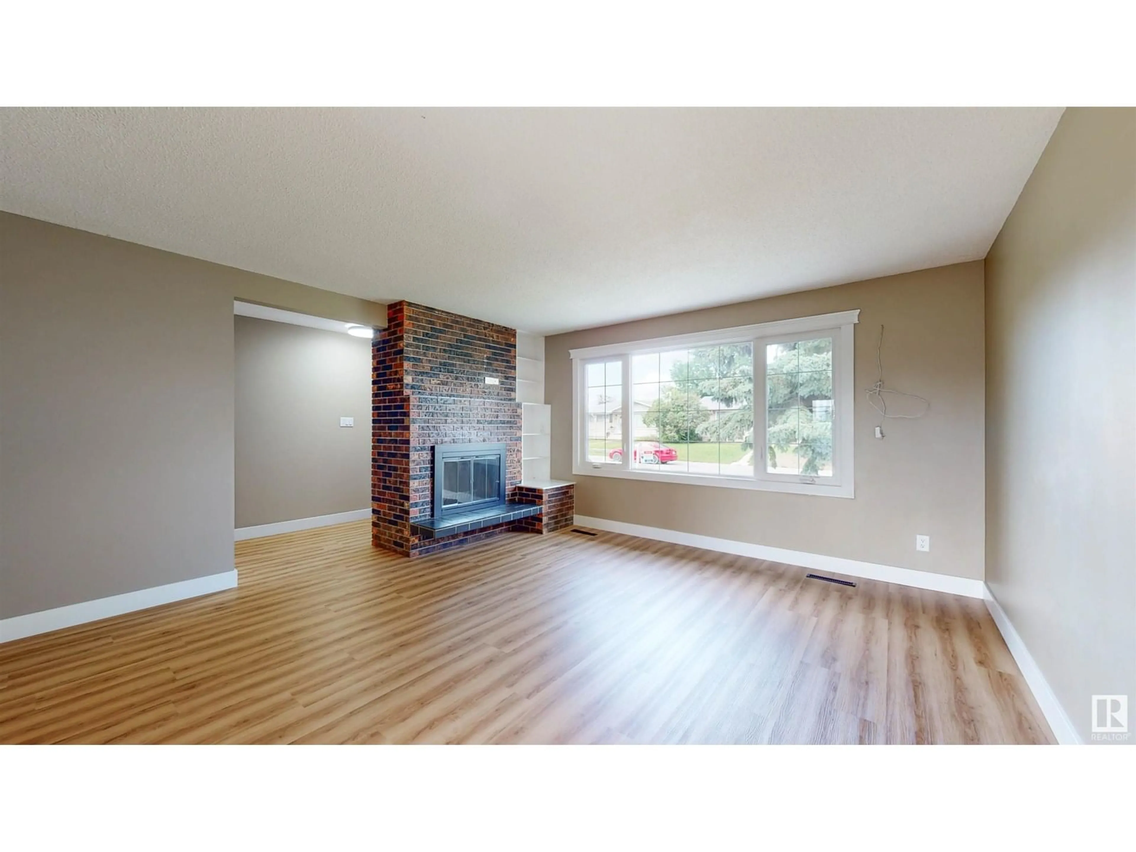 Living room with furniture, wood/laminate floor for 6007 141 AV, Edmonton Alberta T5A1H9