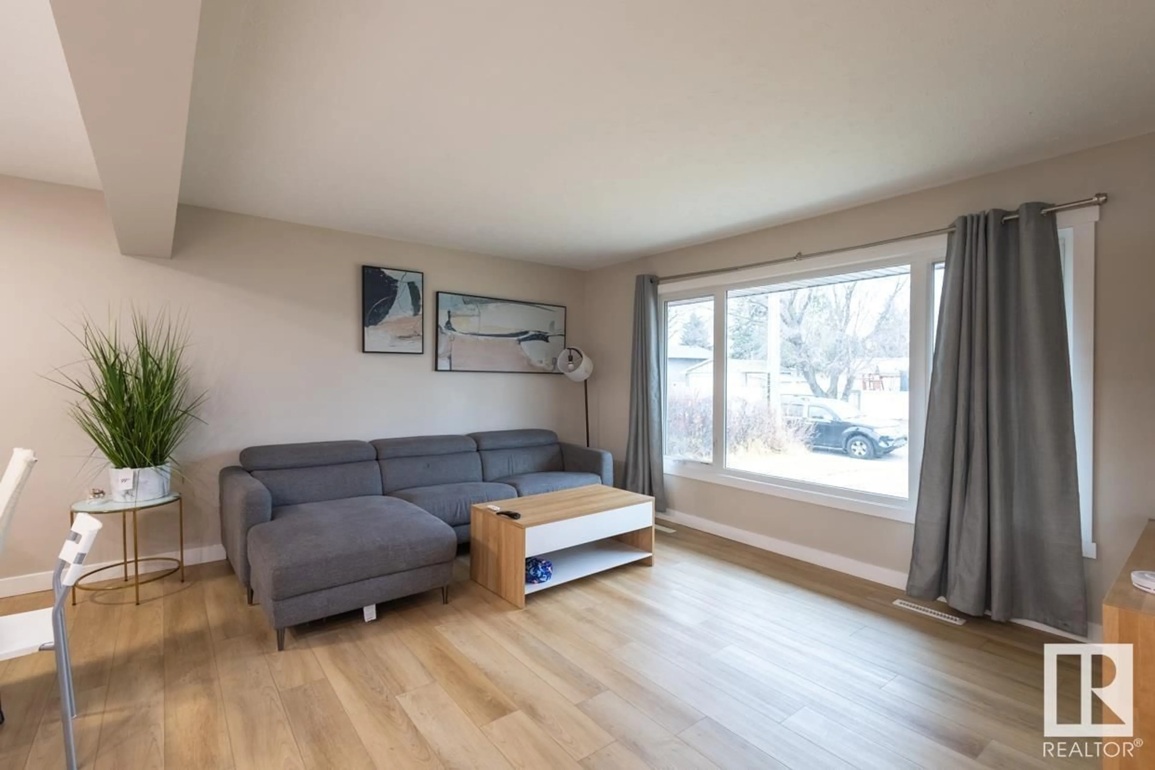 Living room with furniture, wood/laminate floor for 16110 82 AV, Edmonton Alberta T5R3S4