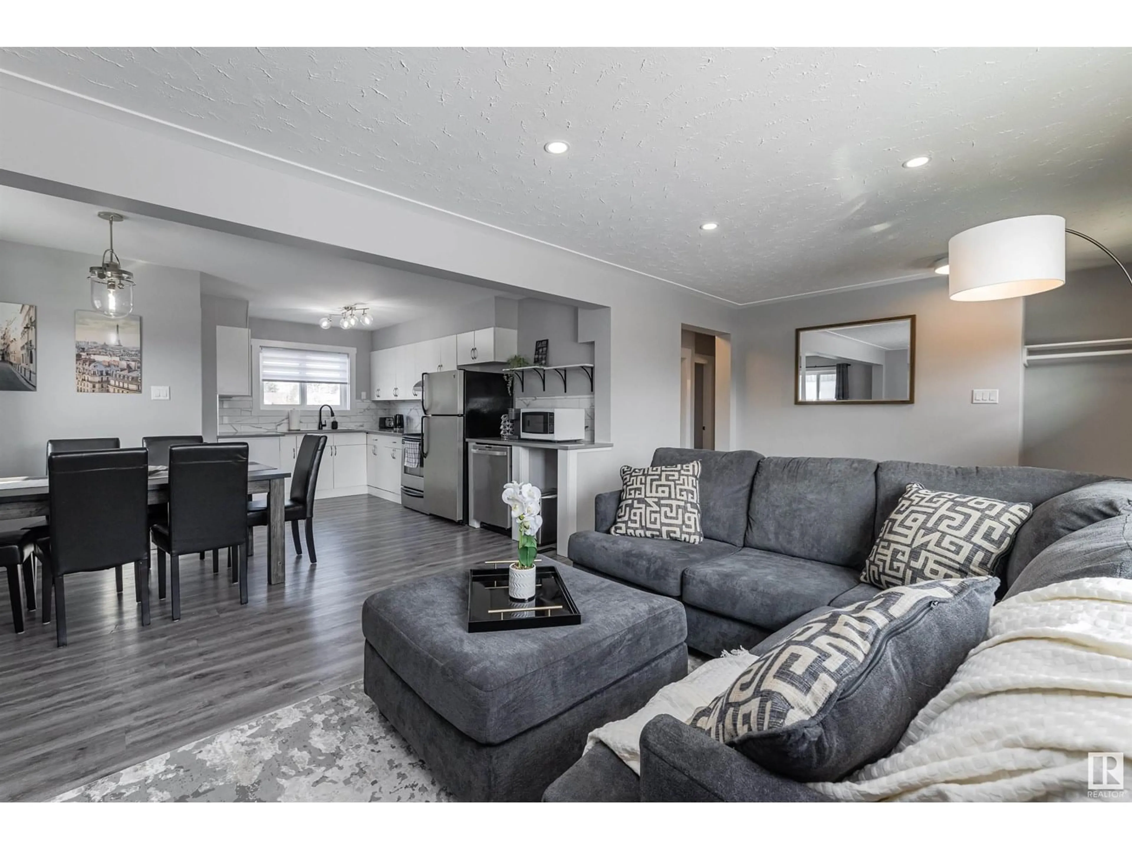 Living room with furniture, wood/laminate floor for NW - 13456 107 ST, Edmonton Alberta T5E4W2