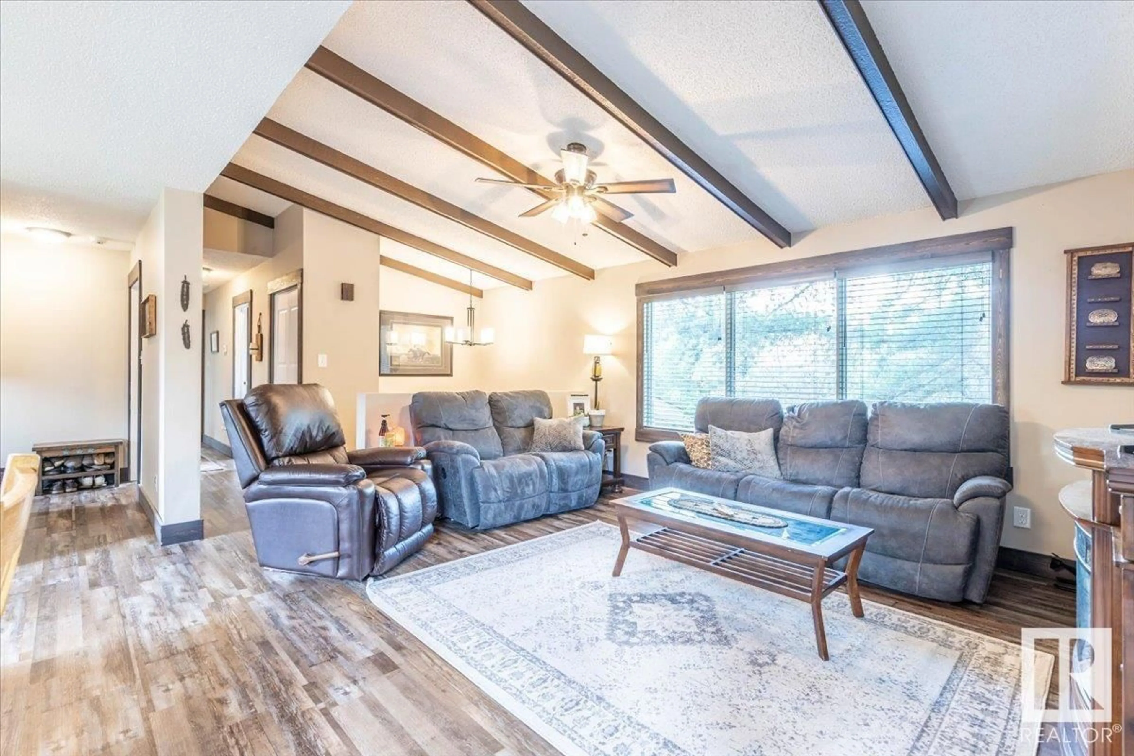 Living room with furniture, wood/laminate floor for 48240 RGE ROAD 275, Rural Leduc County Alberta T0C0V0