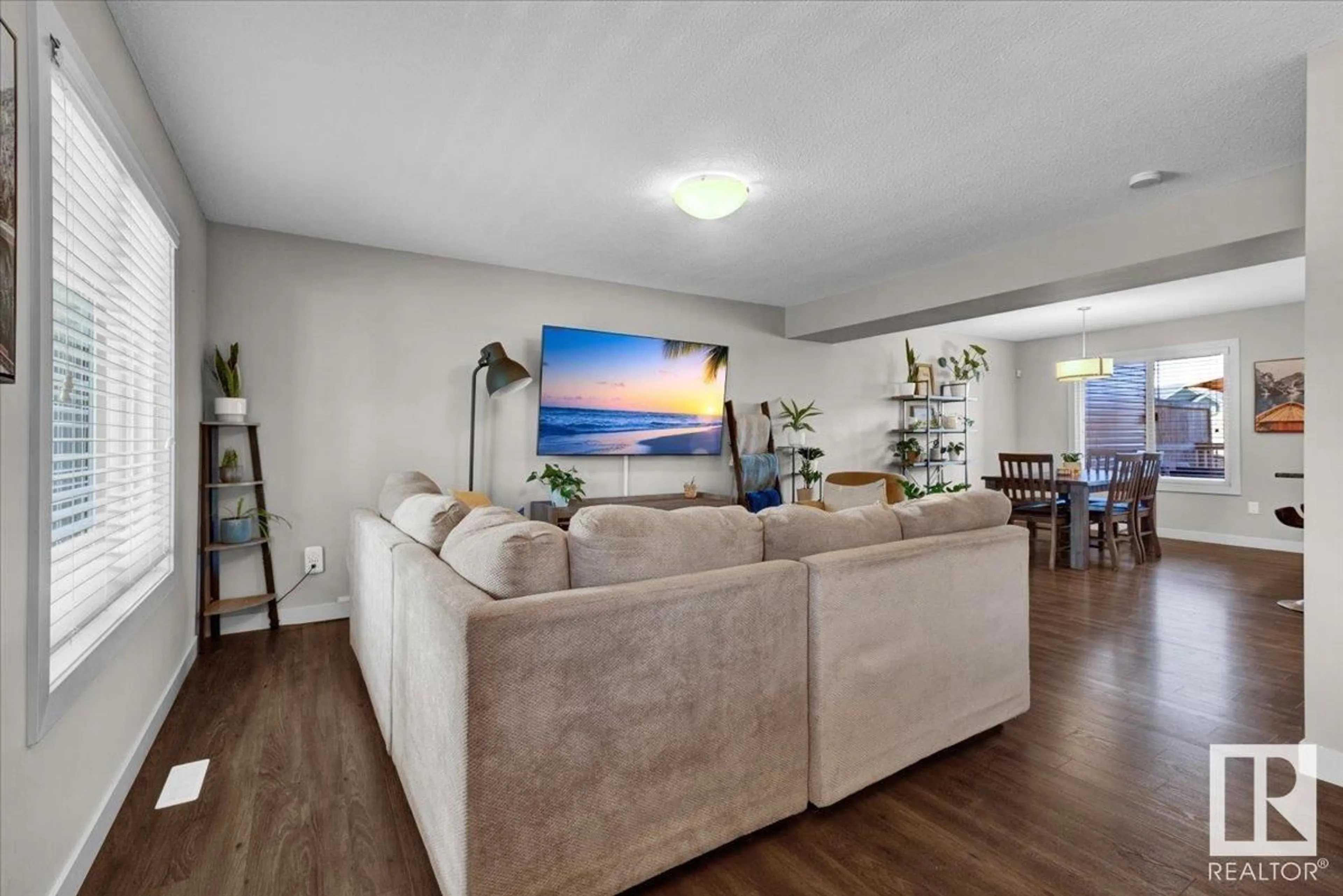 Living room with furniture, wood/laminate floor for 6810 EVANS WD, Edmonton Alberta T6M0T3
