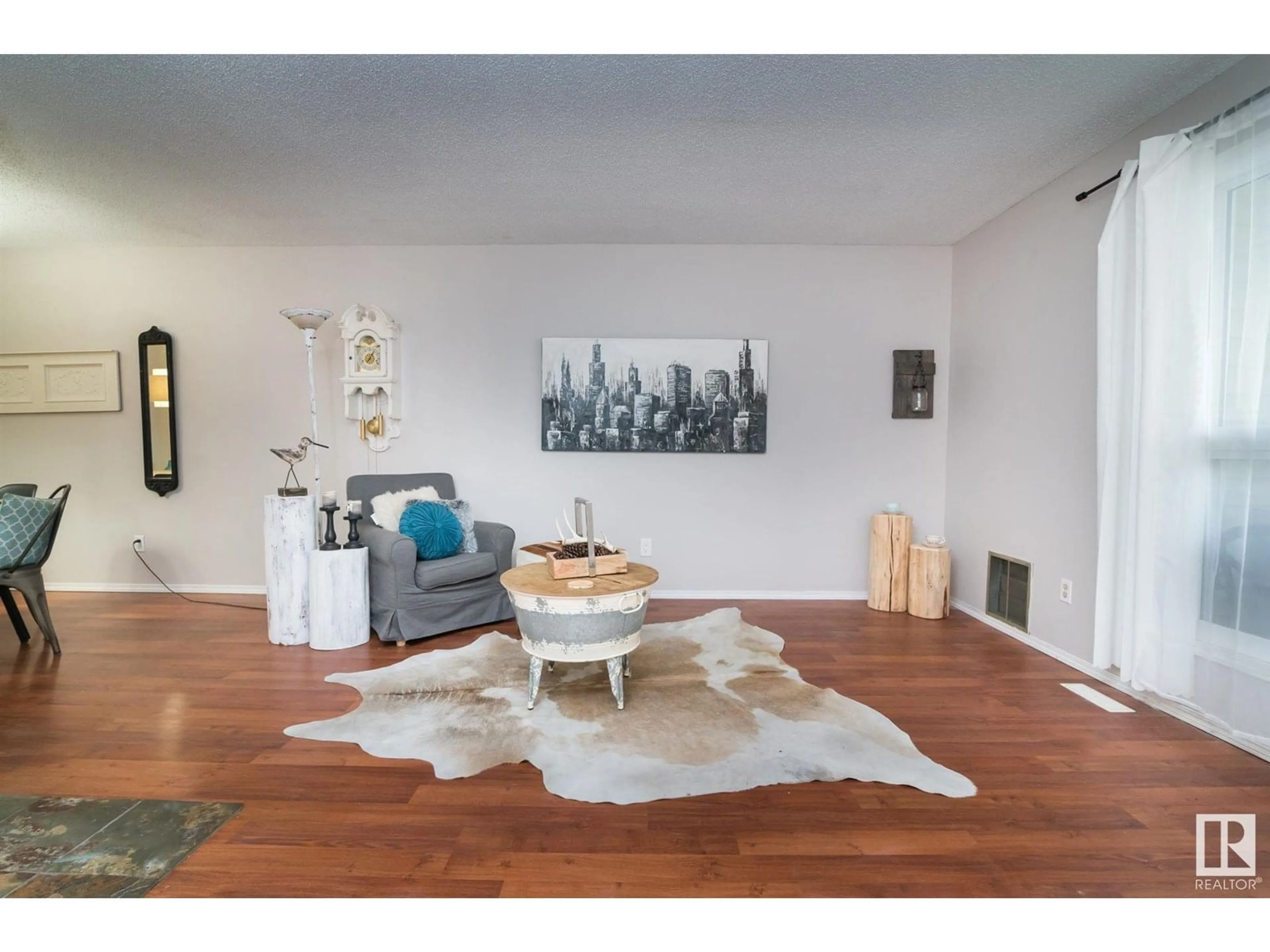 Living room with furniture, wood/laminate floor for 173 - 2703 79 ST NW, Edmonton Alberta T6K3Z6
