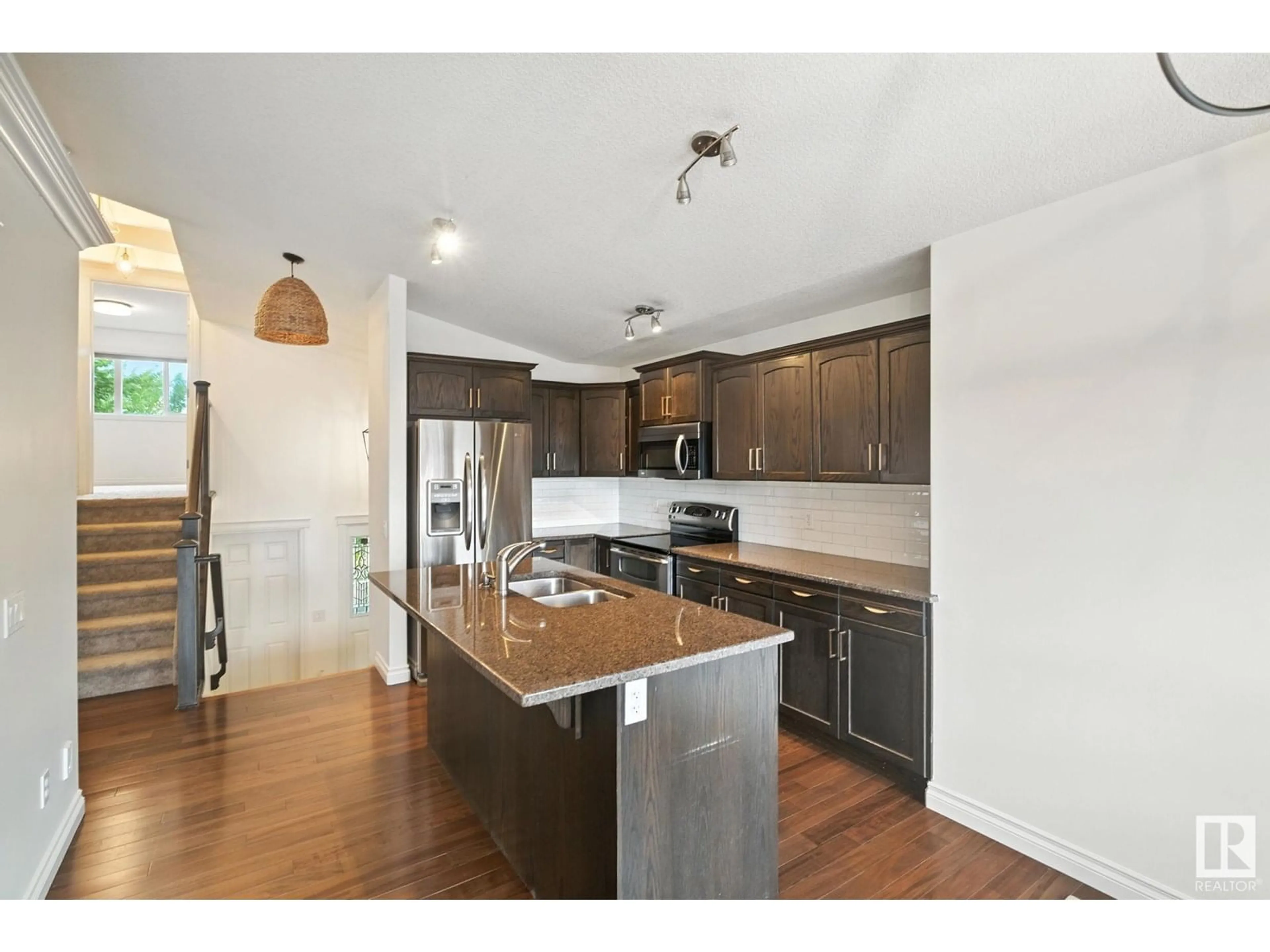 Open concept kitchen, wood/laminate floor for 154 WELLINGTON PLACE, Fort Saskatchewan Alberta T8L0G4