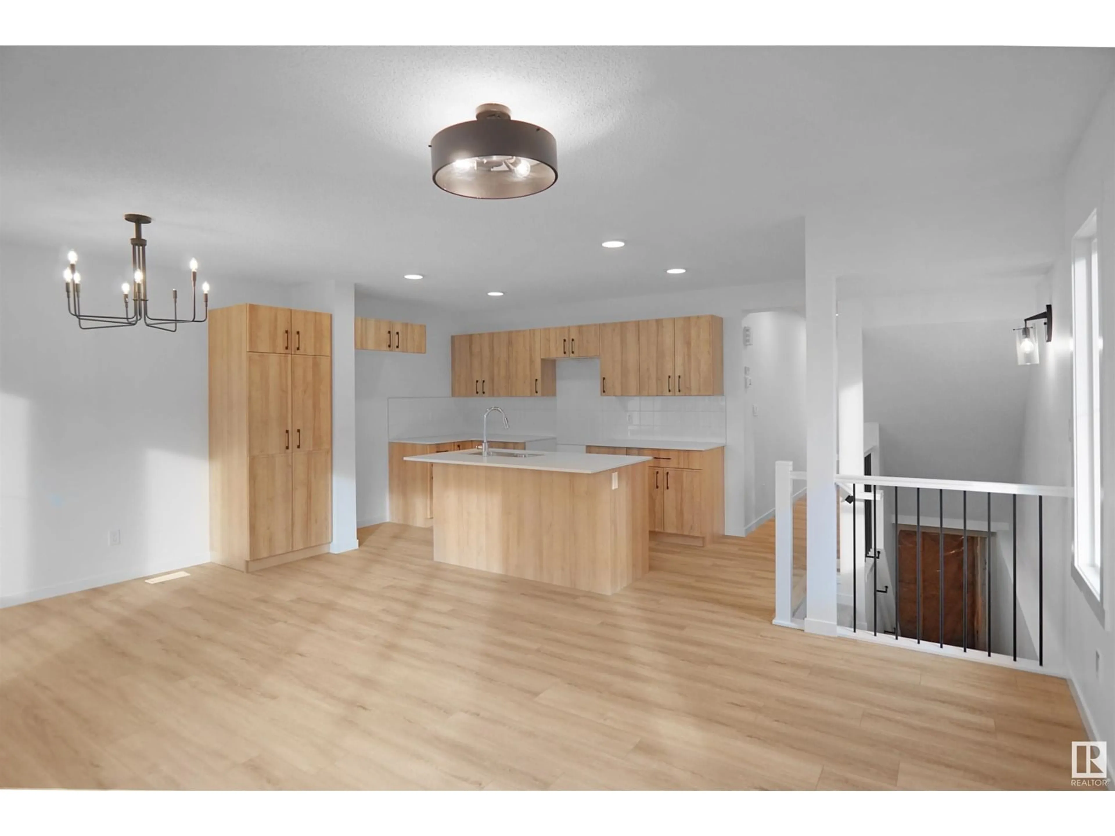 Open concept kitchen, wood/laminate floor for 19904 - 51 31 AV, Edmonton Alberta T6M3B9