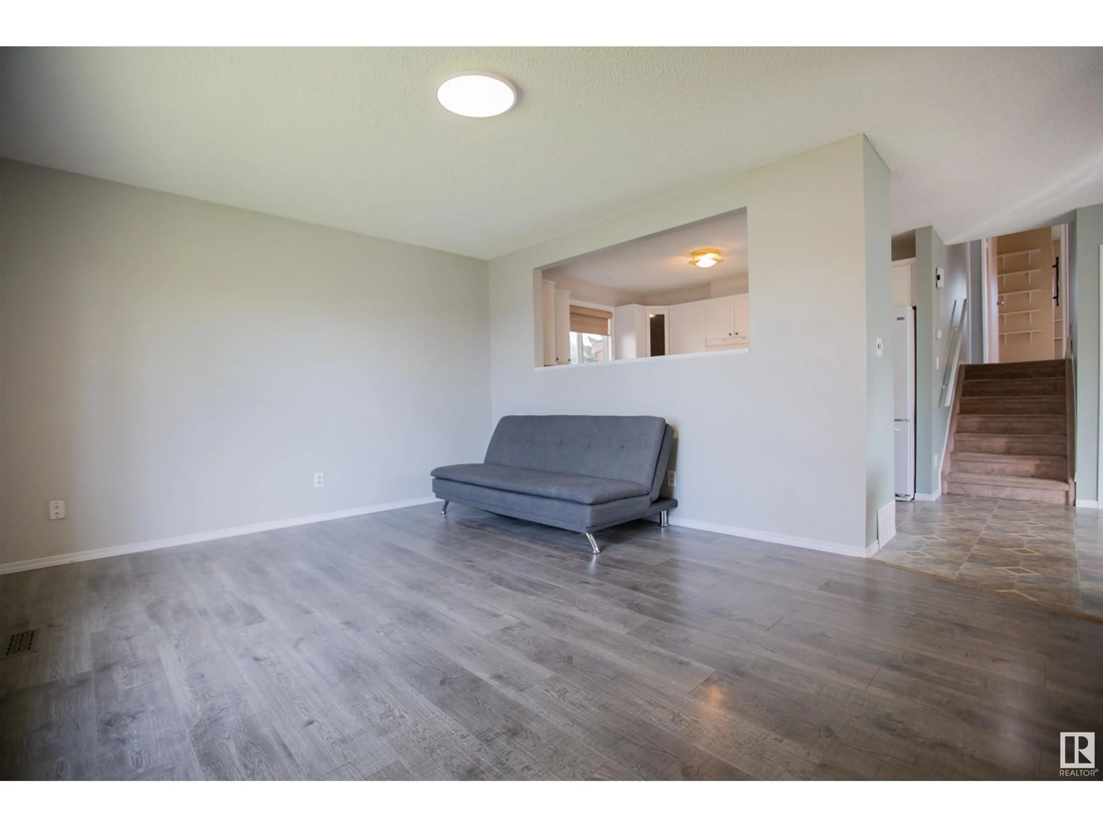 Living room with furniture, wood/laminate floor for 7291 152B AV, Edmonton Alberta T5C3P9