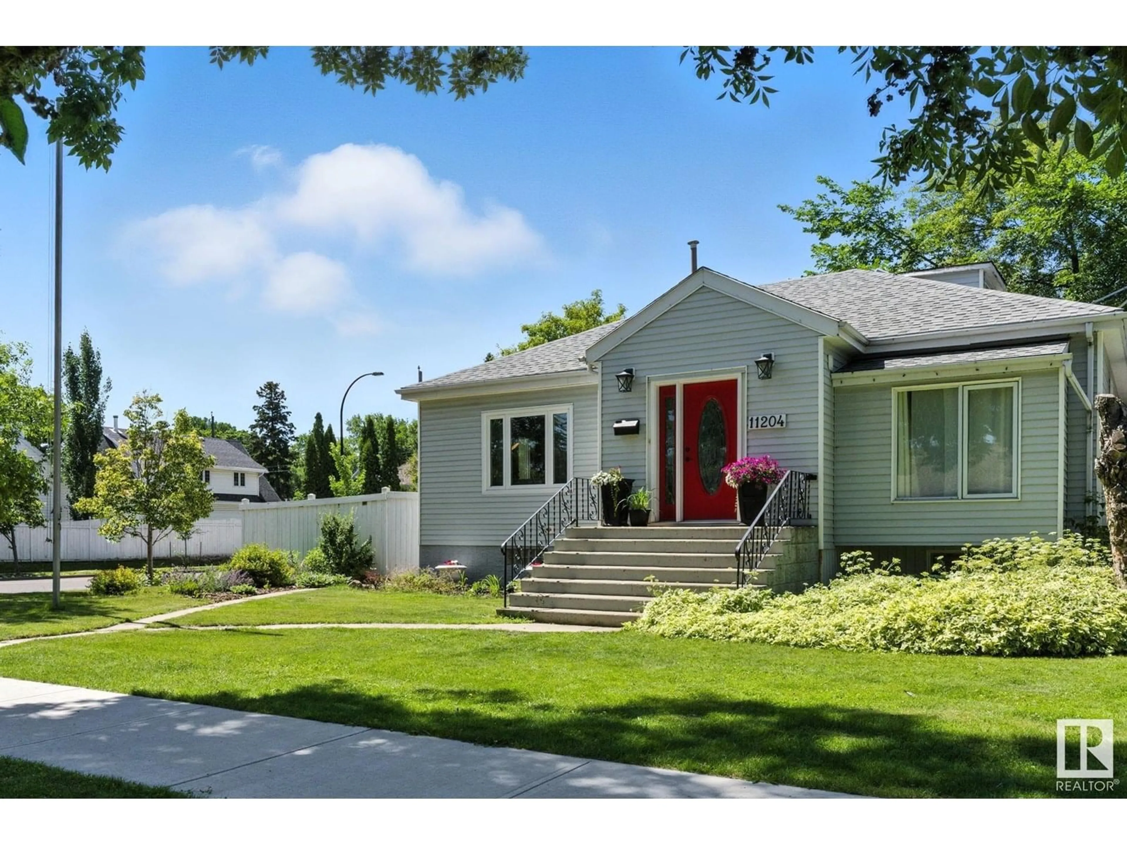 Home with vinyl exterior material, street for NW - 11204 61 ST, Edmonton Alberta T5W4A5