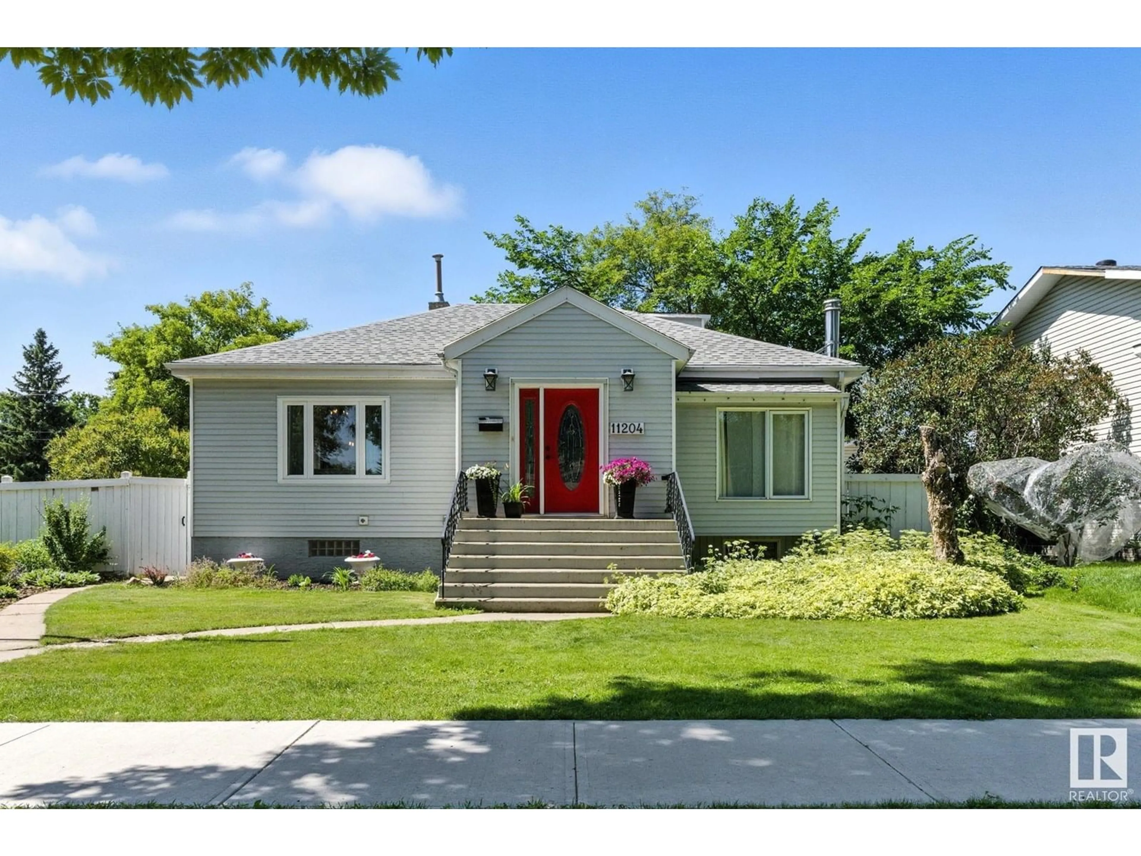 Home with vinyl exterior material, street for NW - 11204 61 ST, Edmonton Alberta T5W4A5
