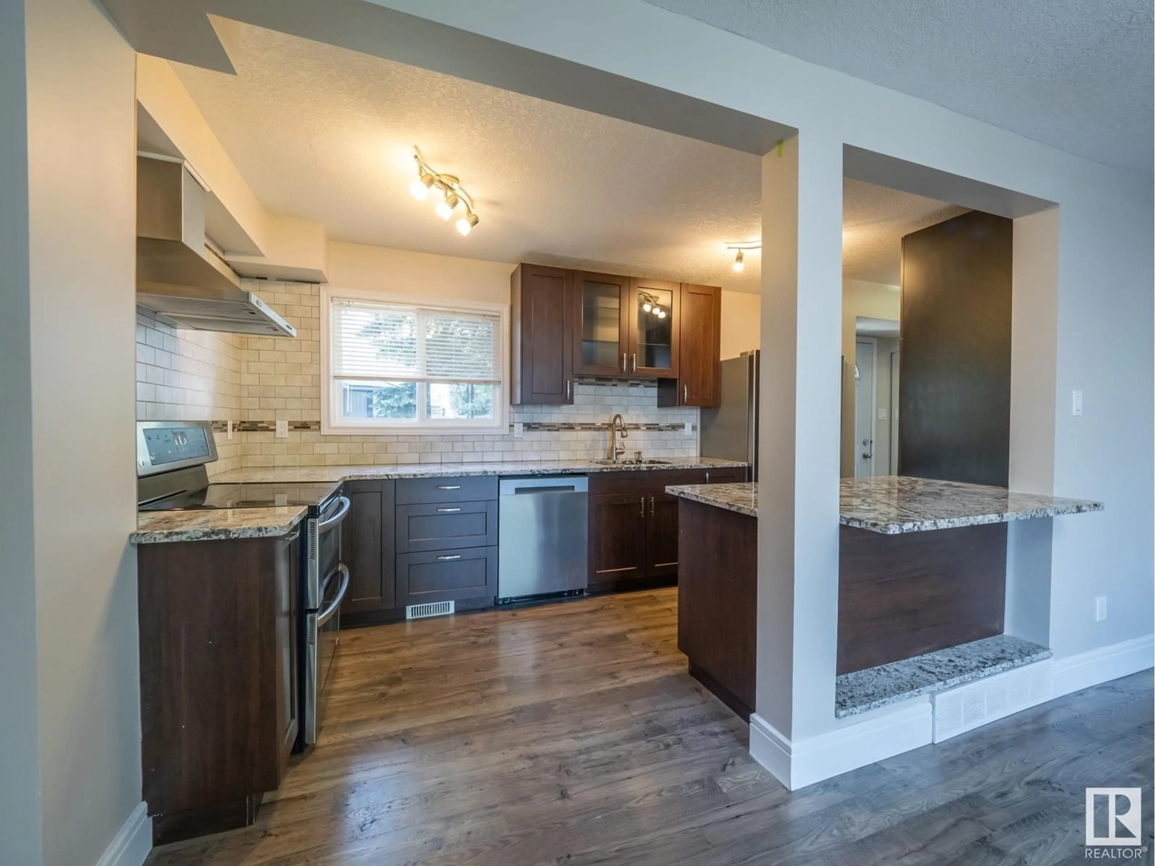 Open concept kitchen, wood/laminate floor for NW - 18422 62B AV, Edmonton Alberta T5T2N7