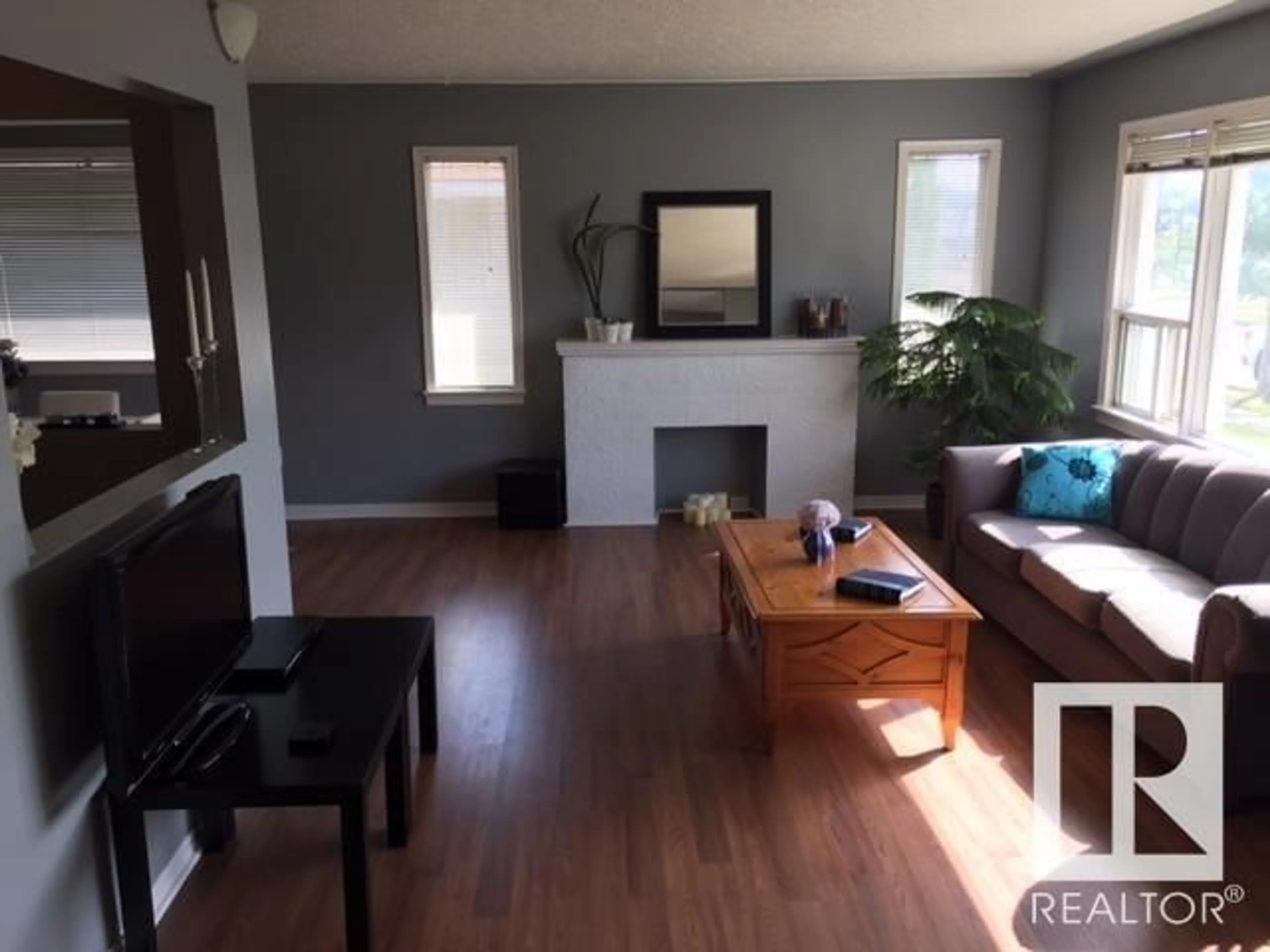 Living room with furniture, wood/laminate floor for 11815 122 ST, Edmonton Alberta T5L0C3