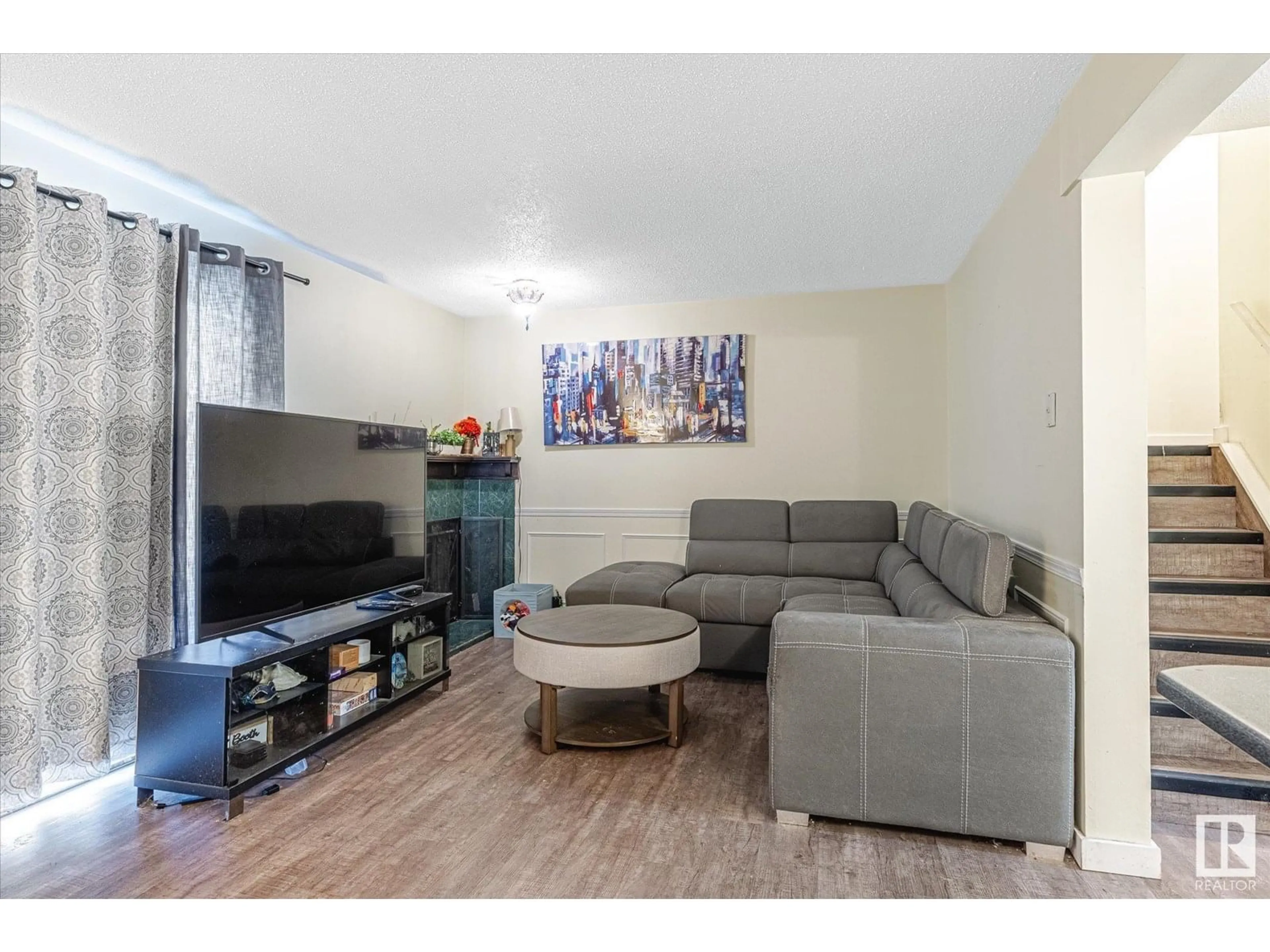Living room with furniture, wood/laminate floor for NW - 14662 121 ST, Edmonton Alberta T5X1T8