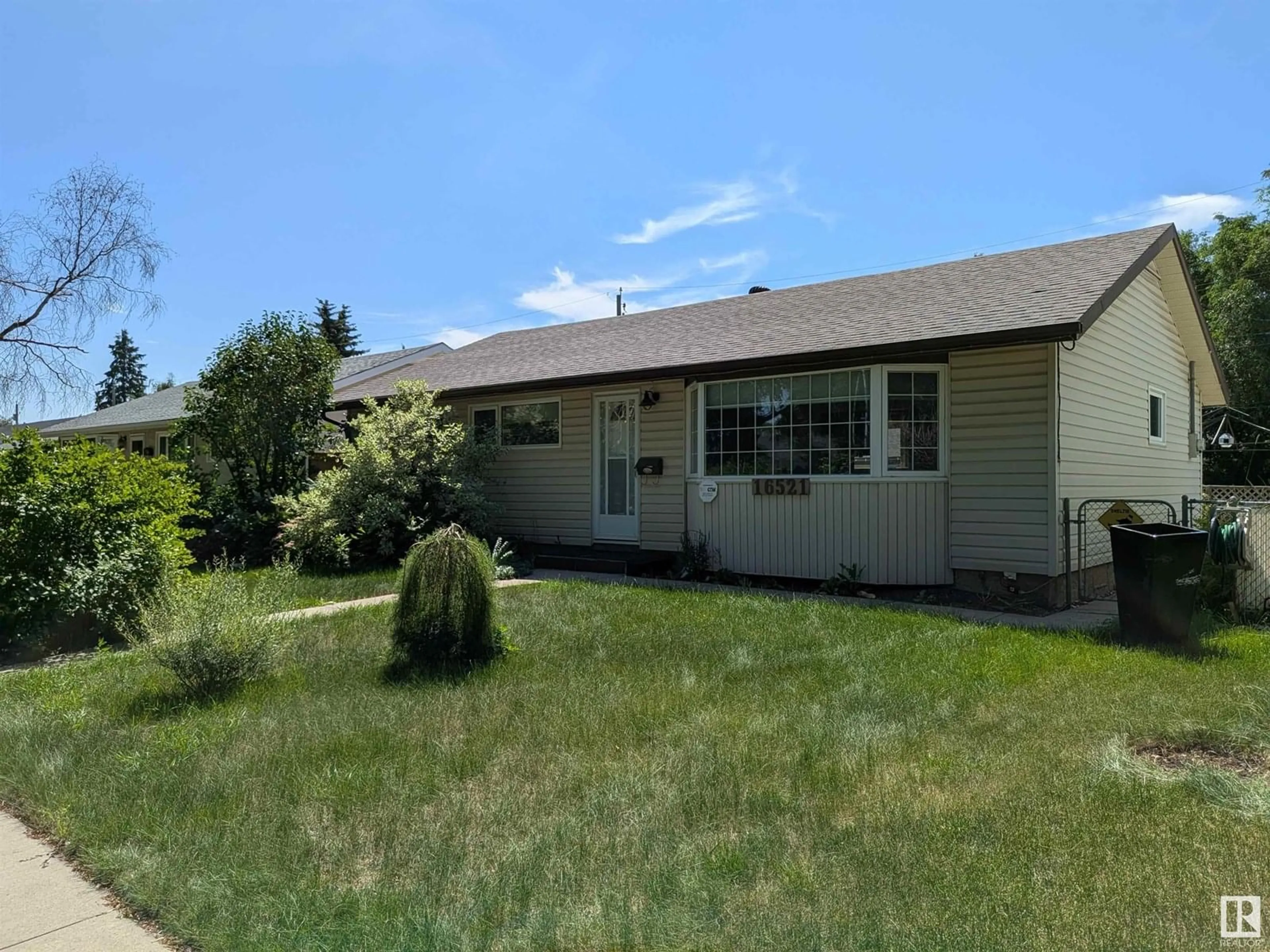 Home with vinyl exterior material, street for 16521 106 AV, Edmonton Alberta T5P0X1