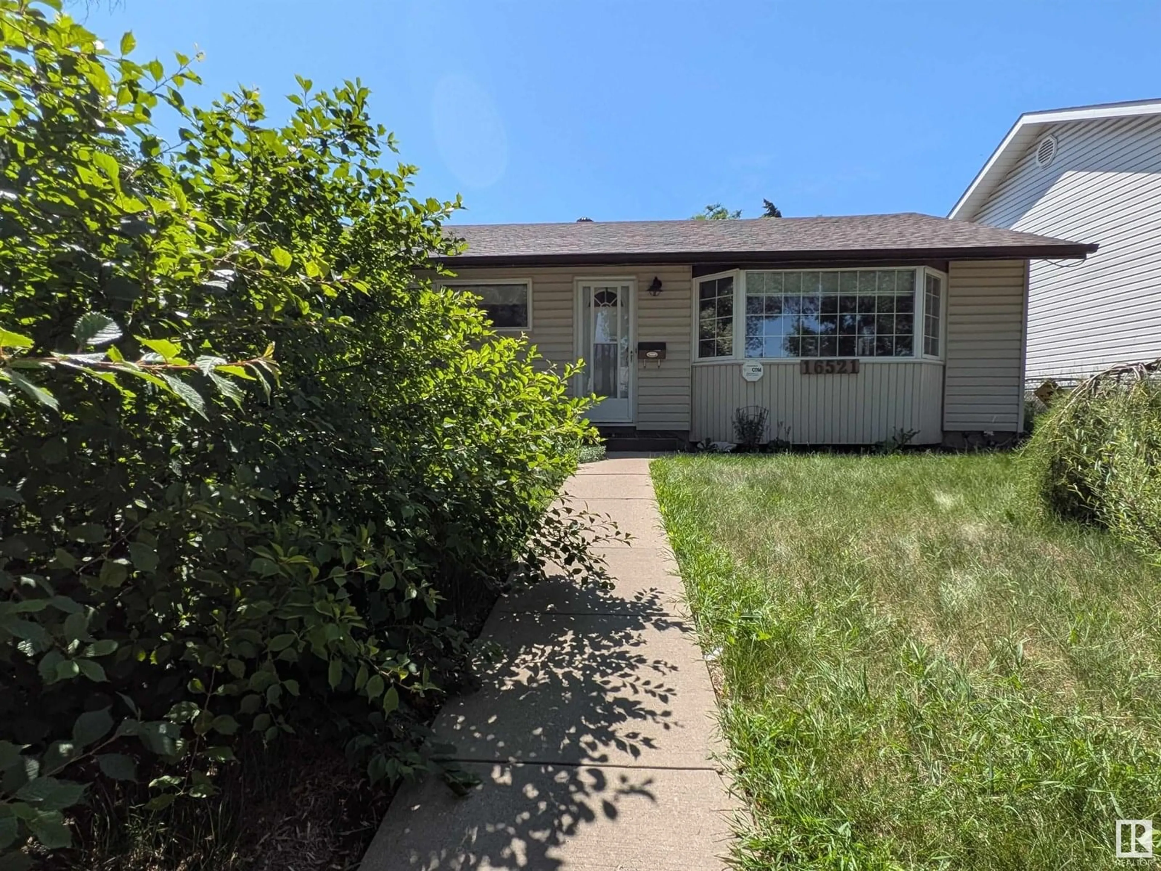 Home with vinyl exterior material, street for 16521 106 AV, Edmonton Alberta T5P0X1