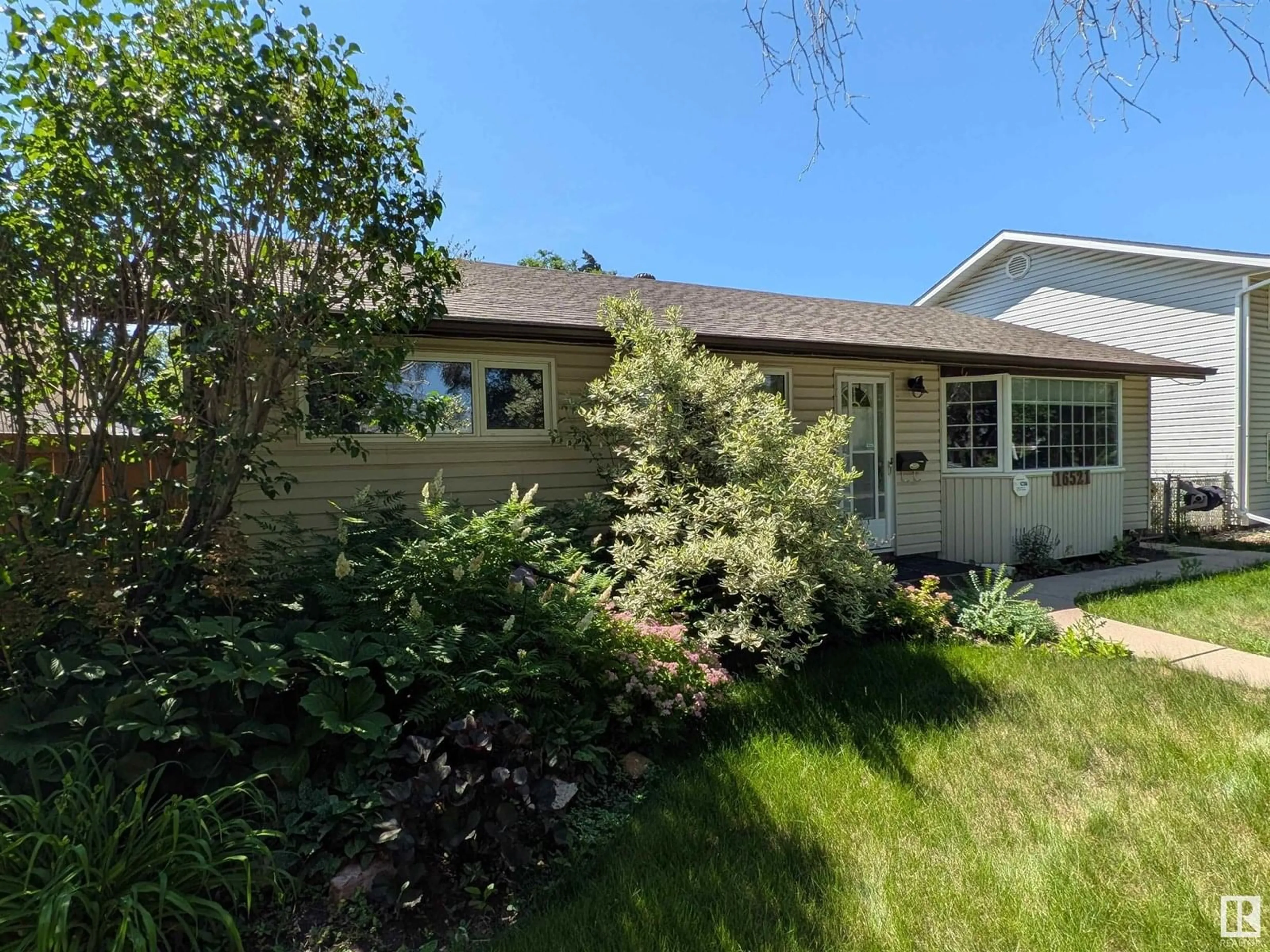 Home with vinyl exterior material, street for 16521 106 AV, Edmonton Alberta T5P0X1