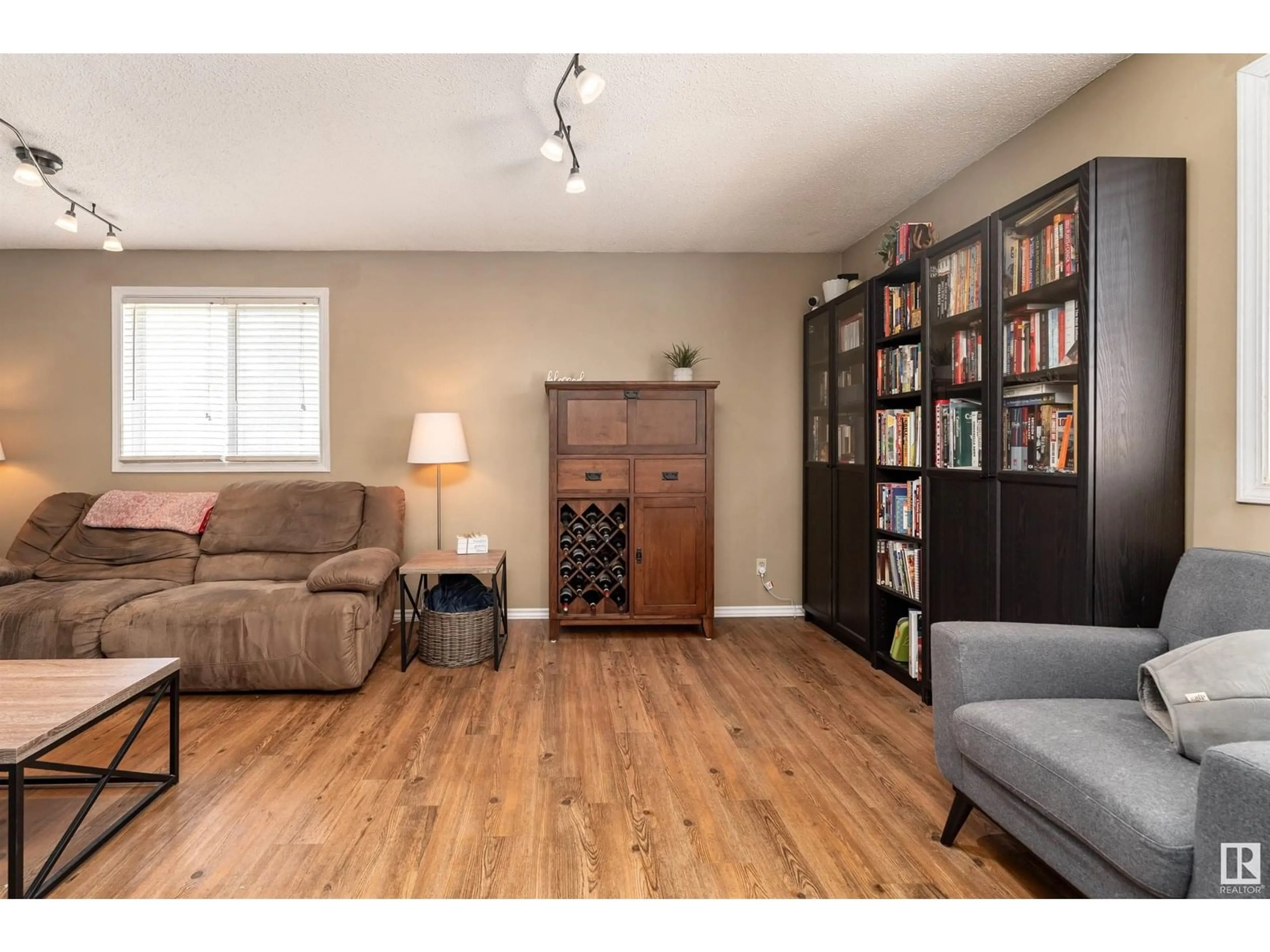 Living room with furniture, wood/laminate floor for 118 - 8930 99 AV, Fort Saskatchewan Alberta T8L3L1
