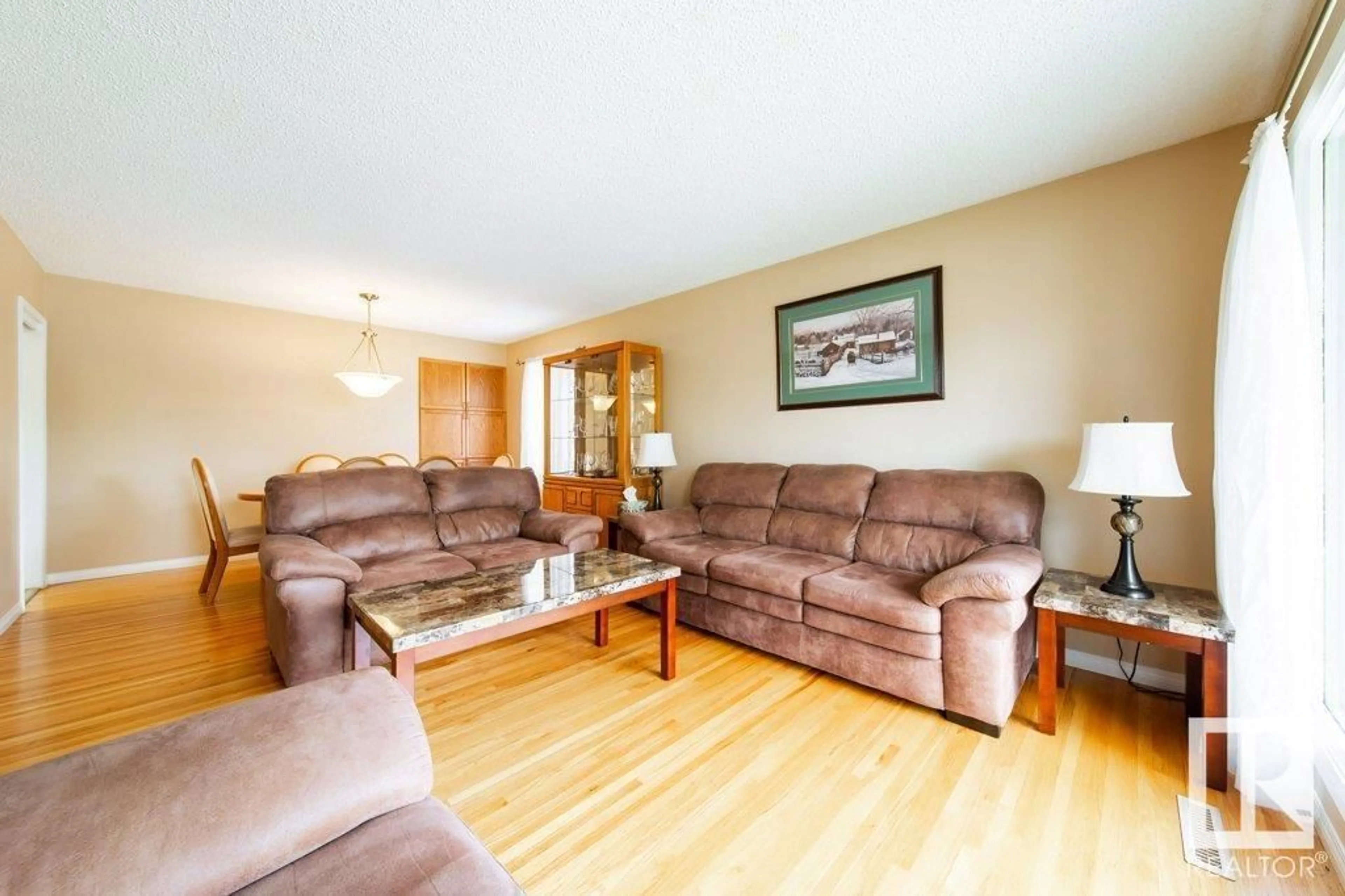 Living room with furniture, wood/laminate floor for NW - 15629 83 AV, Edmonton Alberta T5R3T6